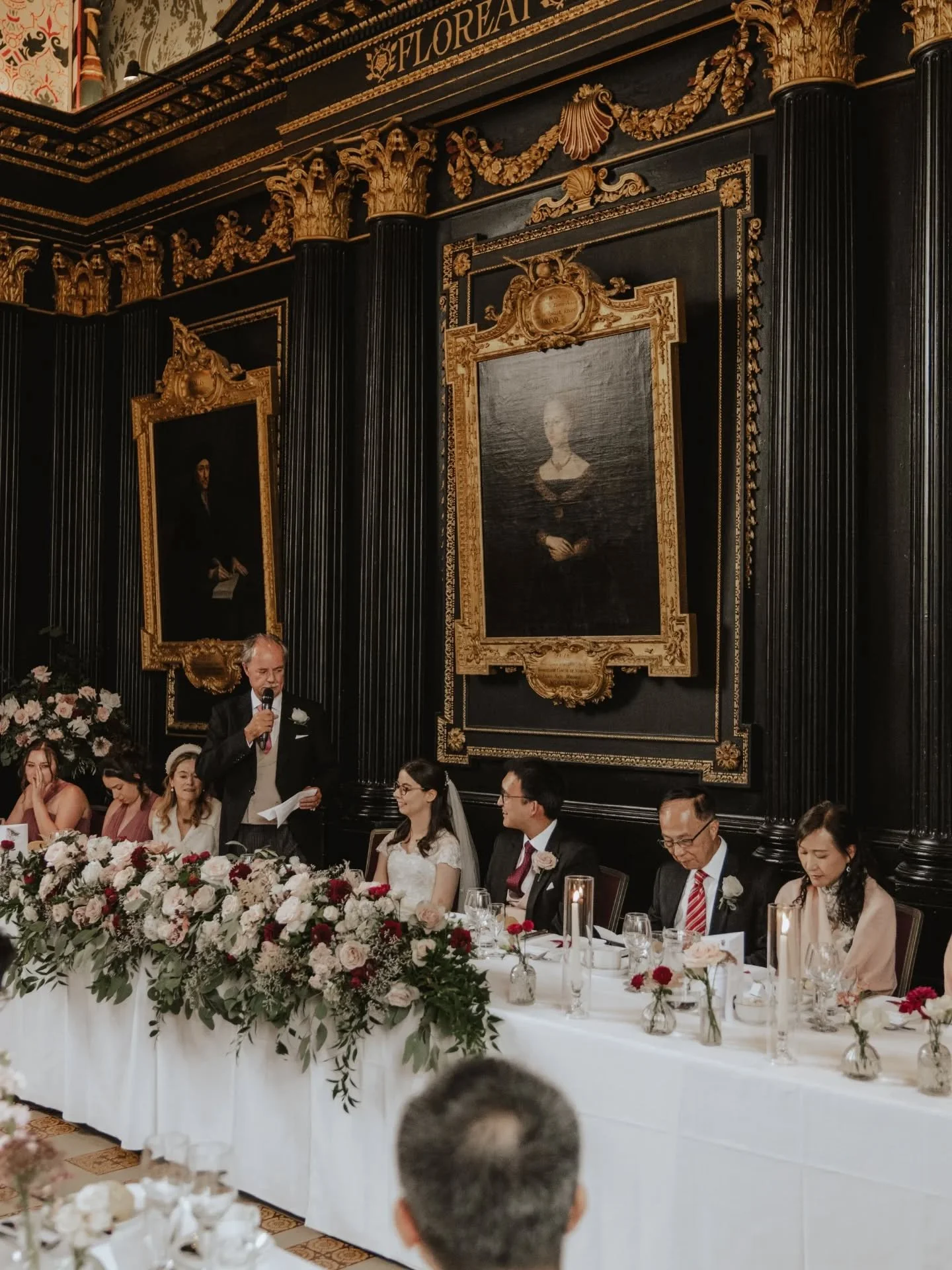 An 8ft traditional style top table arrangement with a mix of dusky pinks &amp; burgundy and loose textured foliage. The perfect focal point of speeches.

Venue @queens_college
Planner @viviennemayweddings 
Photo @charlottewottonphotography 
Mua @camb