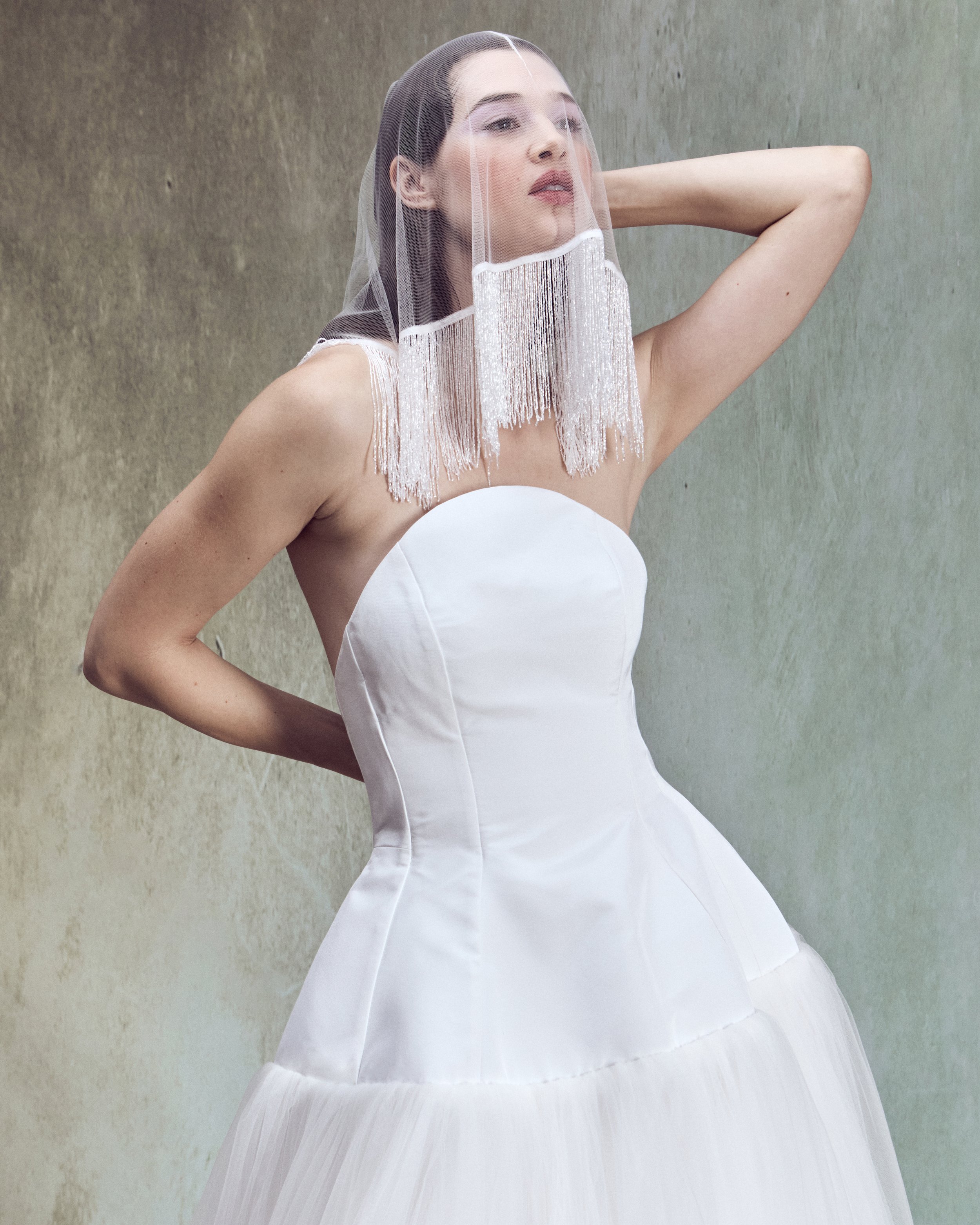 Italian Faille ball gown with sculptural oval high-neck strapless bustier, lace-up back detailing, and drop-waist circle skirt.