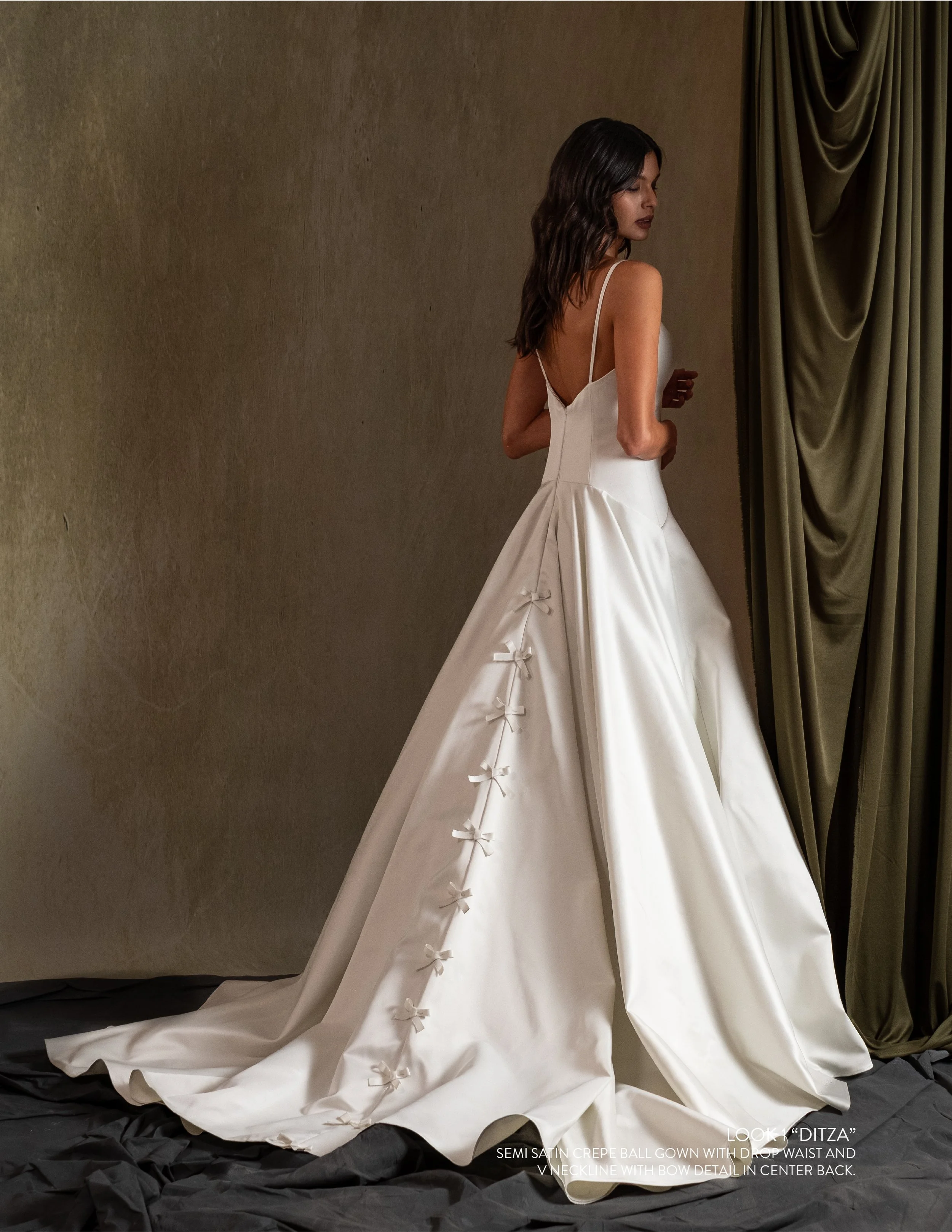 DITZA GOWN - Semi Satin Crepe ball gown with drop waist and V neckline with bow detail in center back.