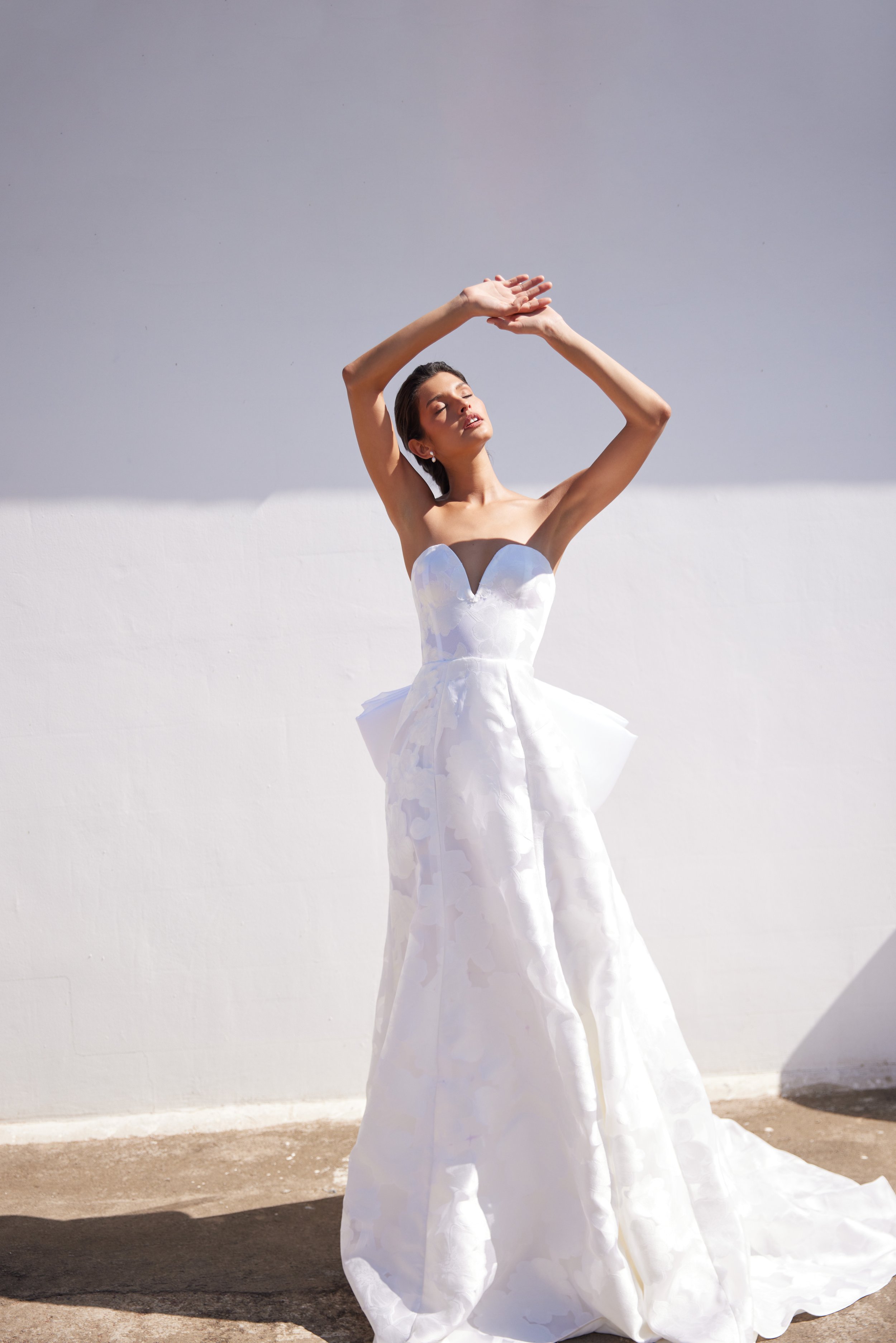 Floral jacquard strapless gown with “A” line skirt, laced back bustier and charra silk removable bow.