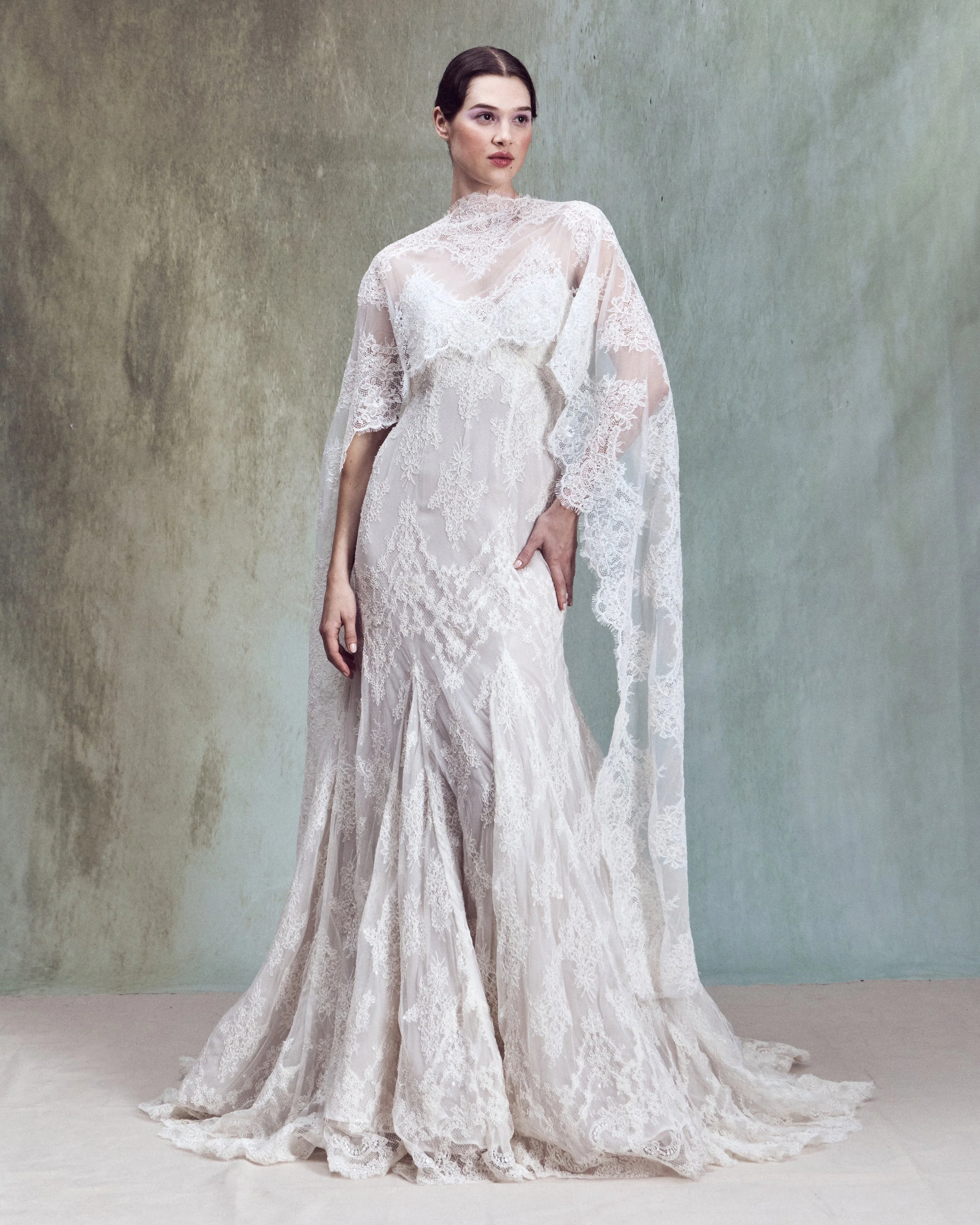 Strapless corded lace applique fit-and-flare gown with a V-shaped neckline and a internal corset matched with a scalloped corded lace capelet draped over the shoulders with an open back