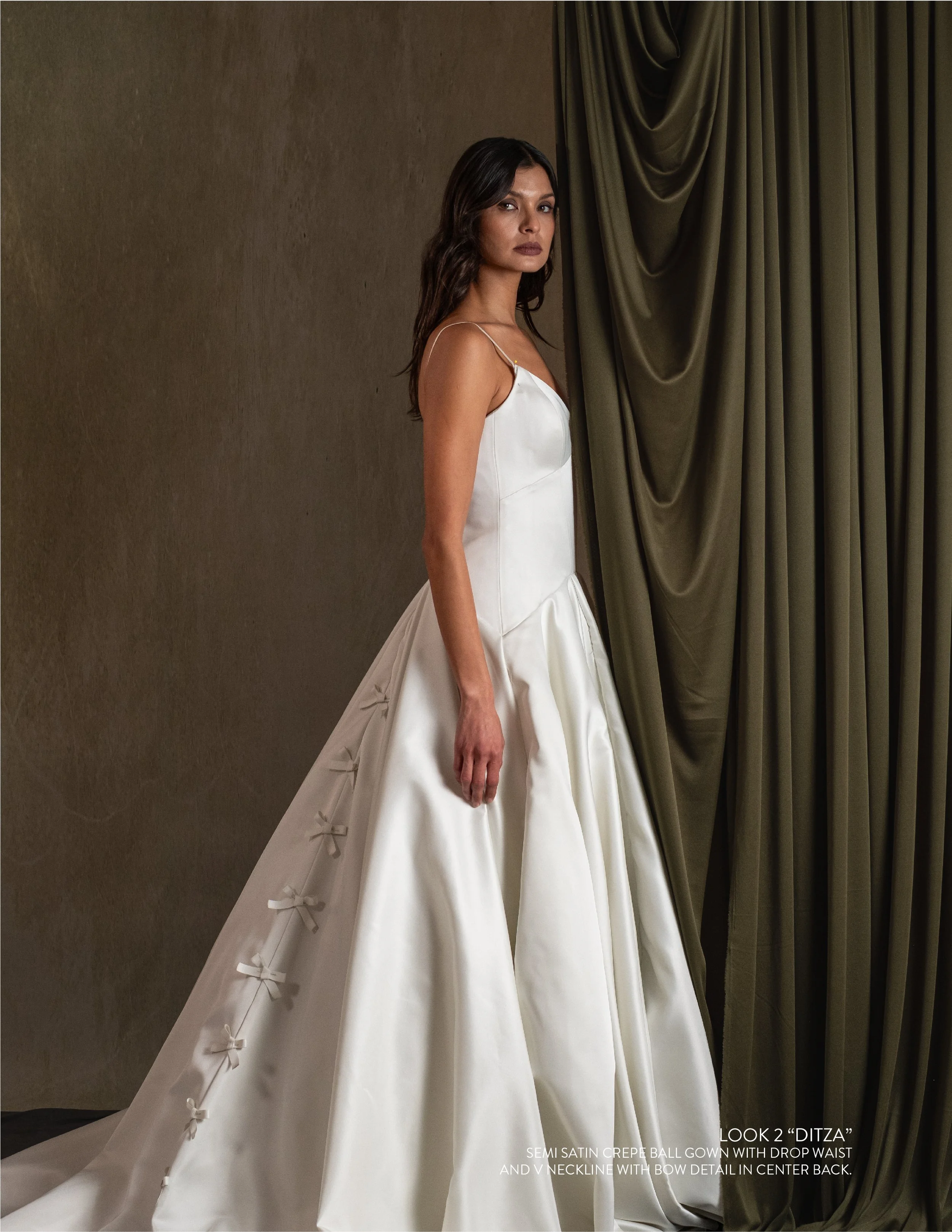 DITZA GOWN - Semi Satin Crepe ball gown with drop waist and V neckline with bow detail in center back.
