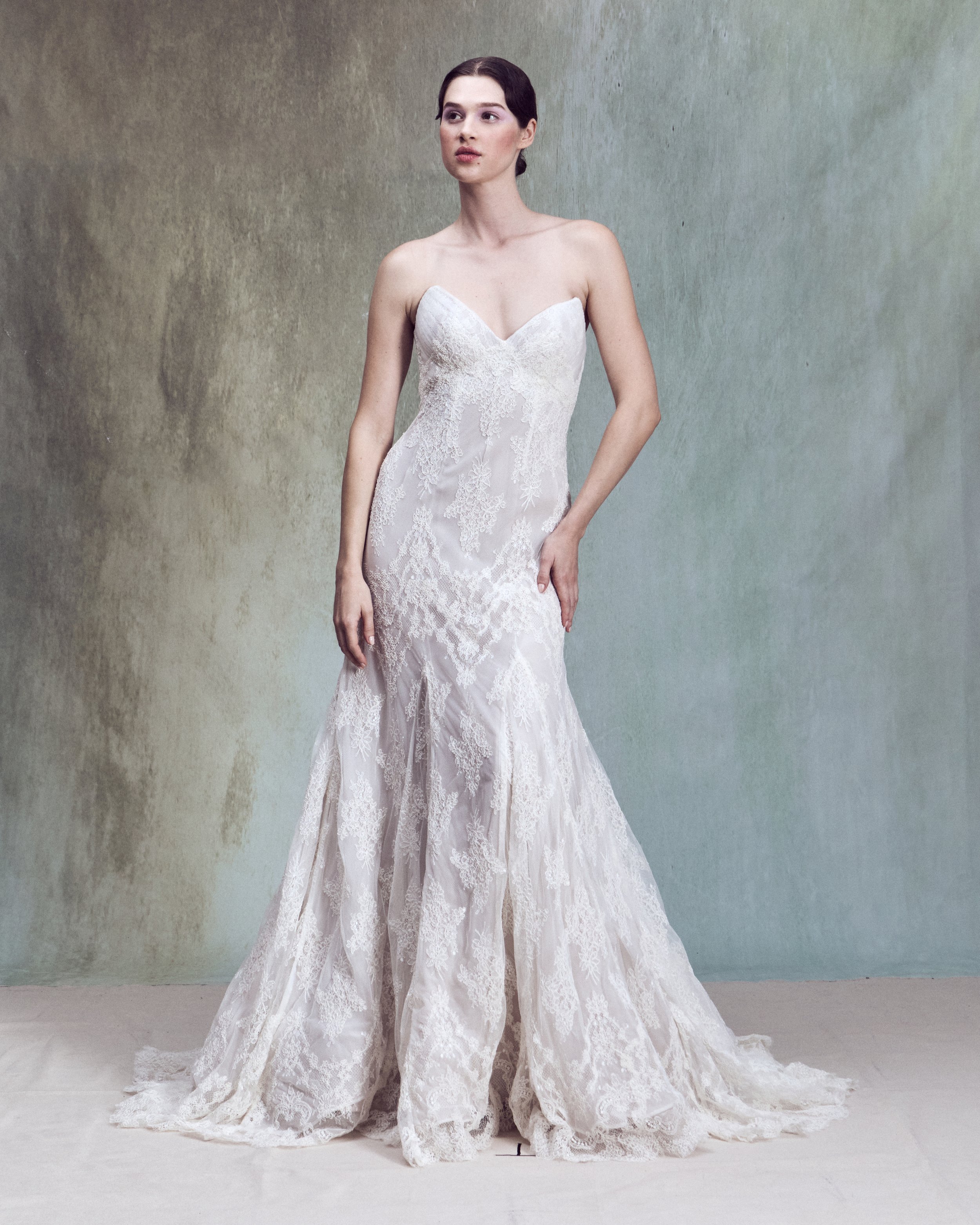 Strapless corded lace applique fit-and-flare gown with a V-shaped neckline and a internal corset matched with a scalloped corded lace capelet draped over the shoulders with an open back