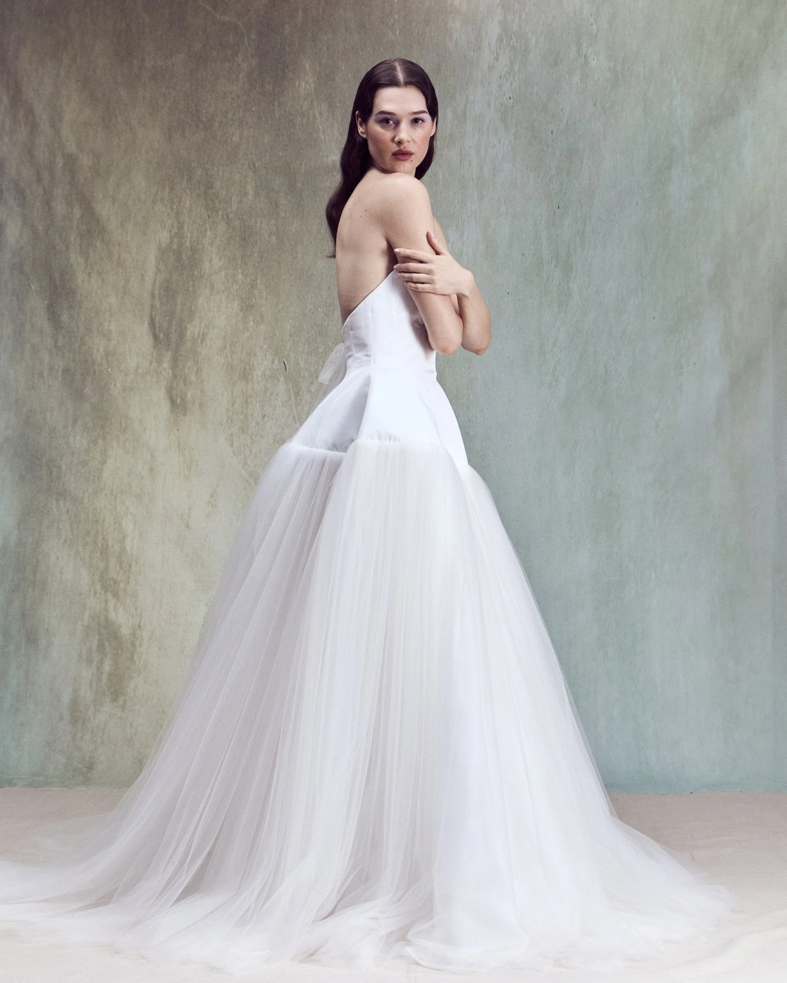 Italian Faille ball gown with sculptural oval high-neck strapless bustier, lace-up back detailing, and drop-waist circle skirt.