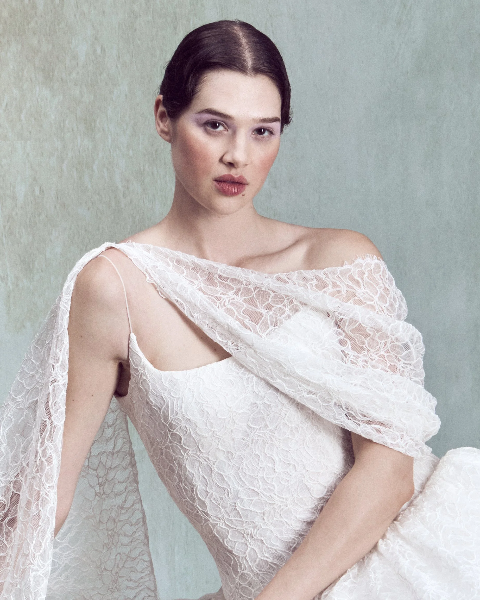 Corded lace gown with a straight-neckline bustier, delicate spaghetti straps, a low back, and drop-waist circle skirt. 