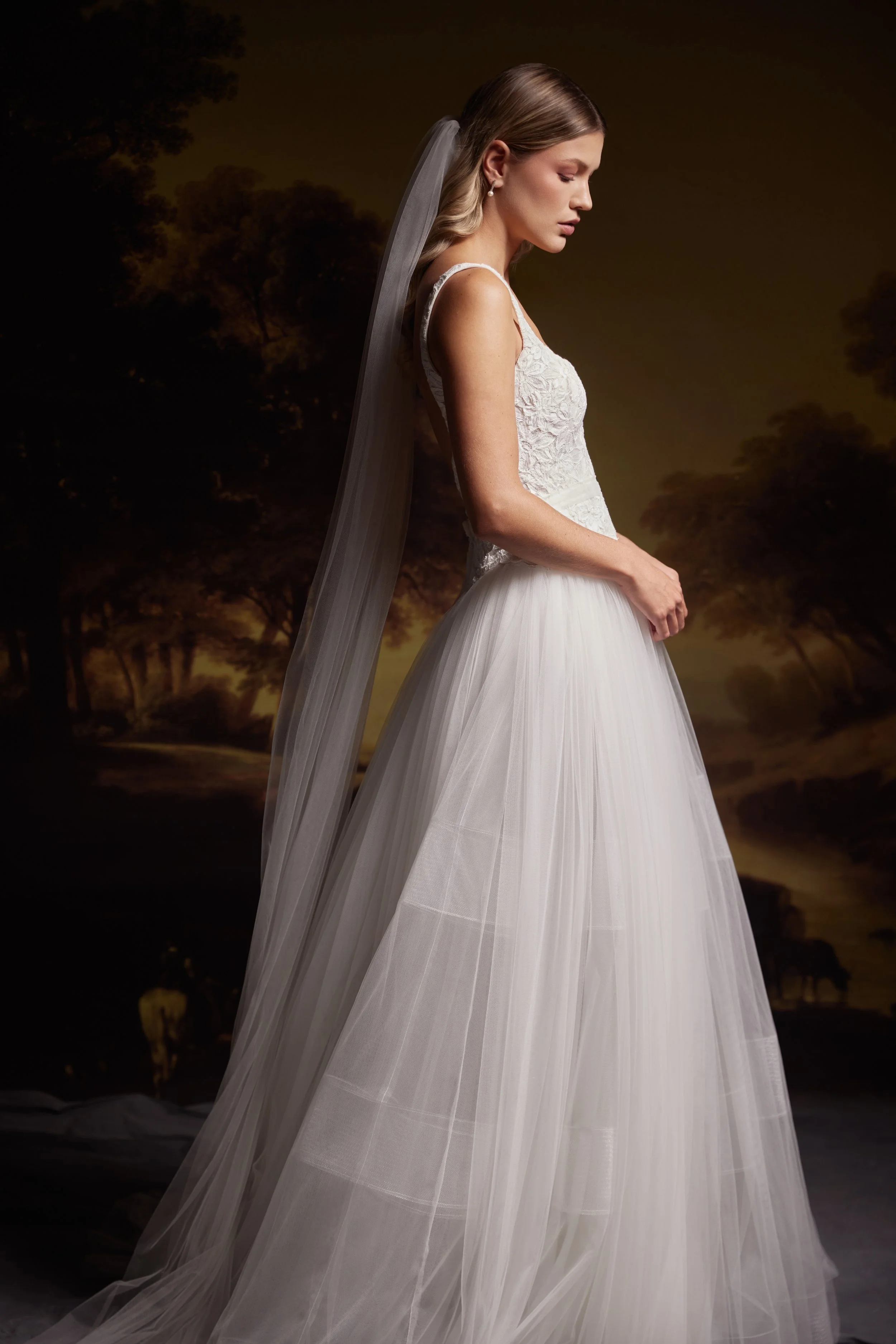 Ball gown with french corded iris lace bodice with straps and low back with a voluminous tulle skirt. 