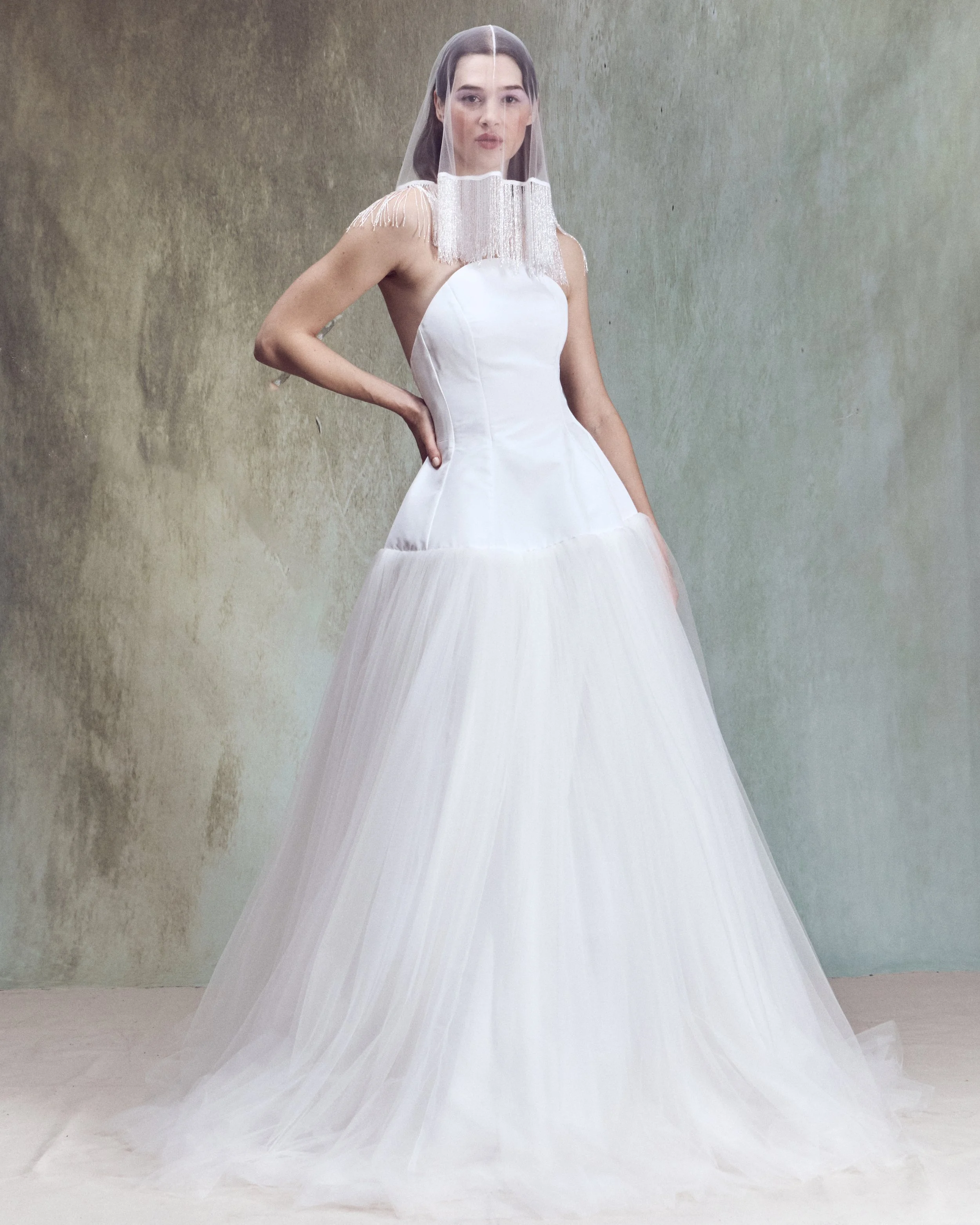 Italian Faille ball gown with sculptural oval high-neck strapless bustier, lace-up back detailing, and drop-waist circle skirt.