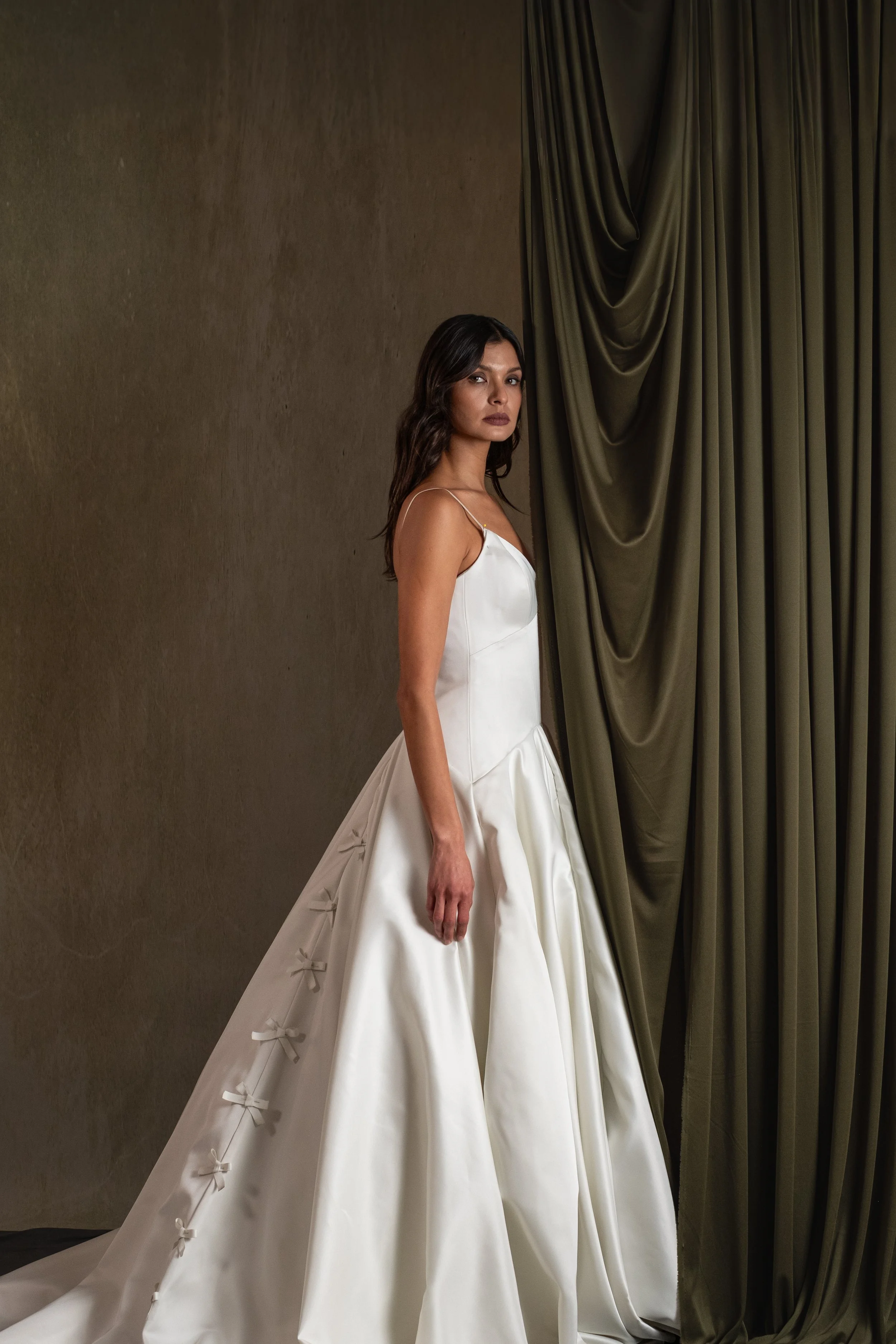 DITZA GOWN - Semi Satin Crepe ball gown with drop waist and V neckline with bow detail in center back.