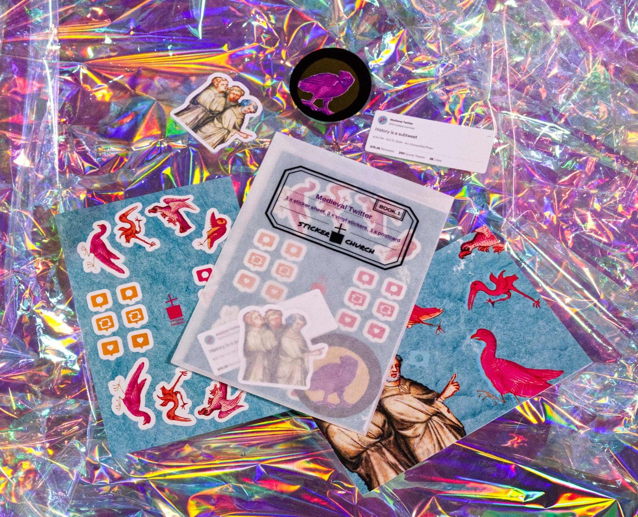A set of stickers, postcard and sticker sheet arranged around a glassine envelope labelled Medieval Twitter: The Set