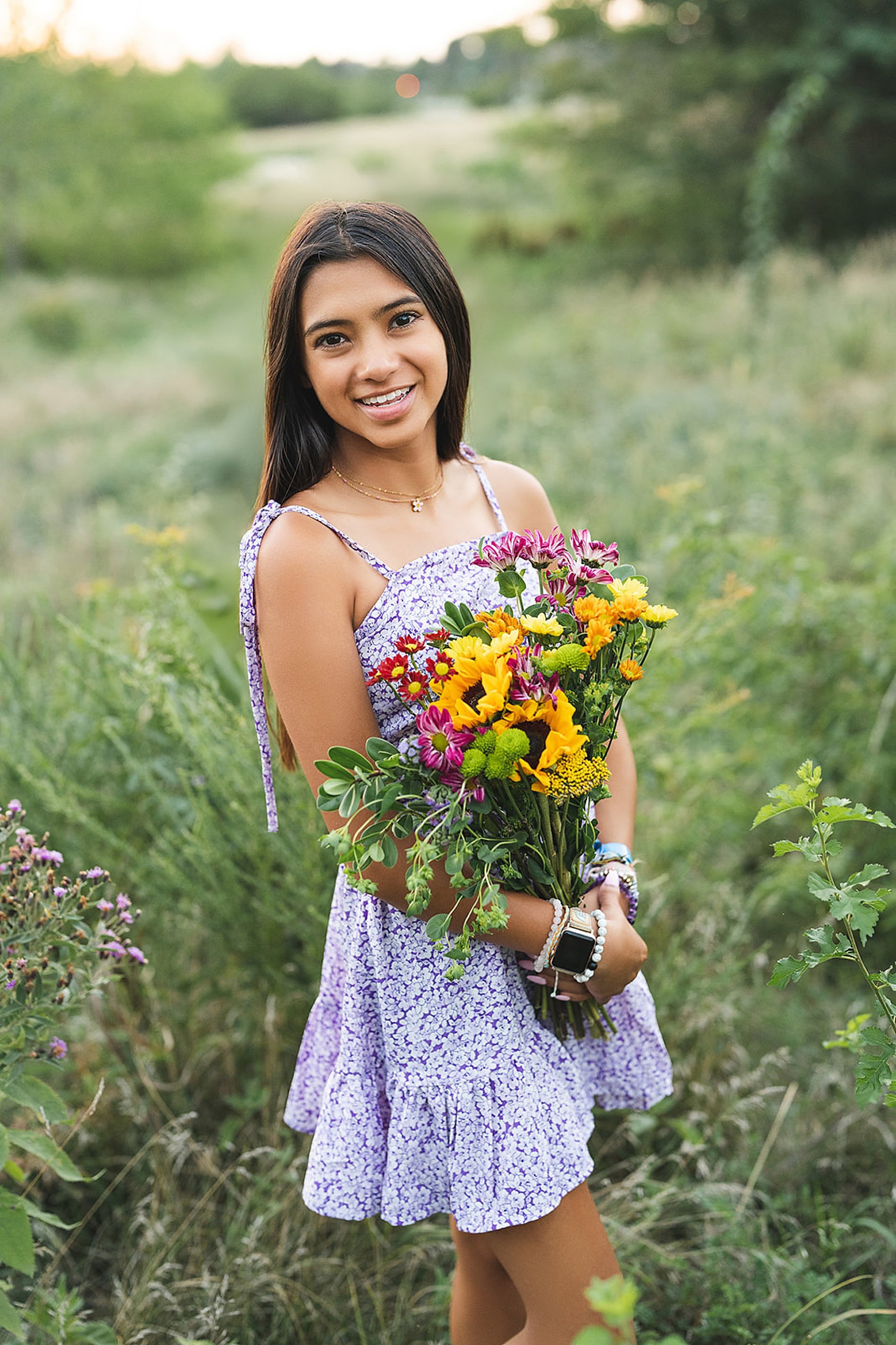  Senior girl open field holding summer bouquet  