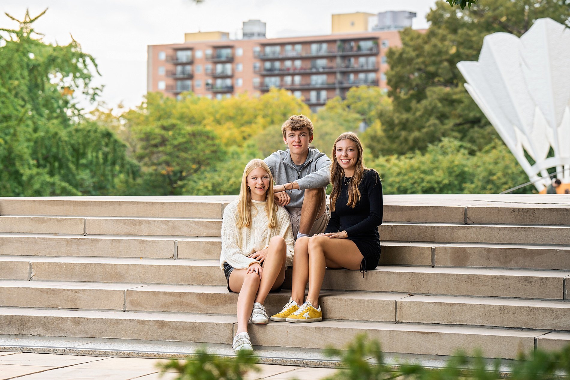  three siblings ist on stairs during KC family portraits 