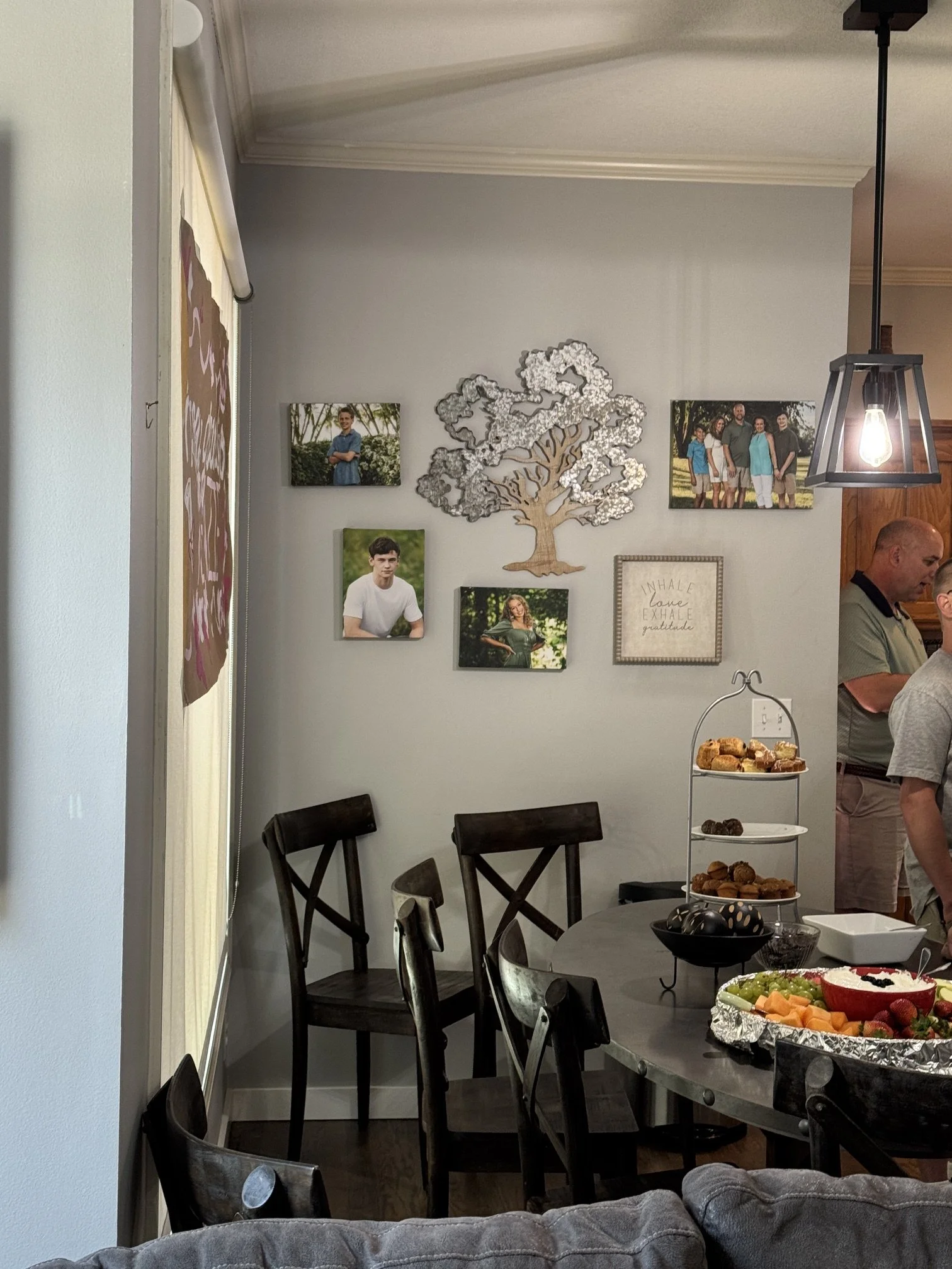  Gallery wall with multiple framed family and senior portraits in a Kansas City home by Aimee Geis Photography 
