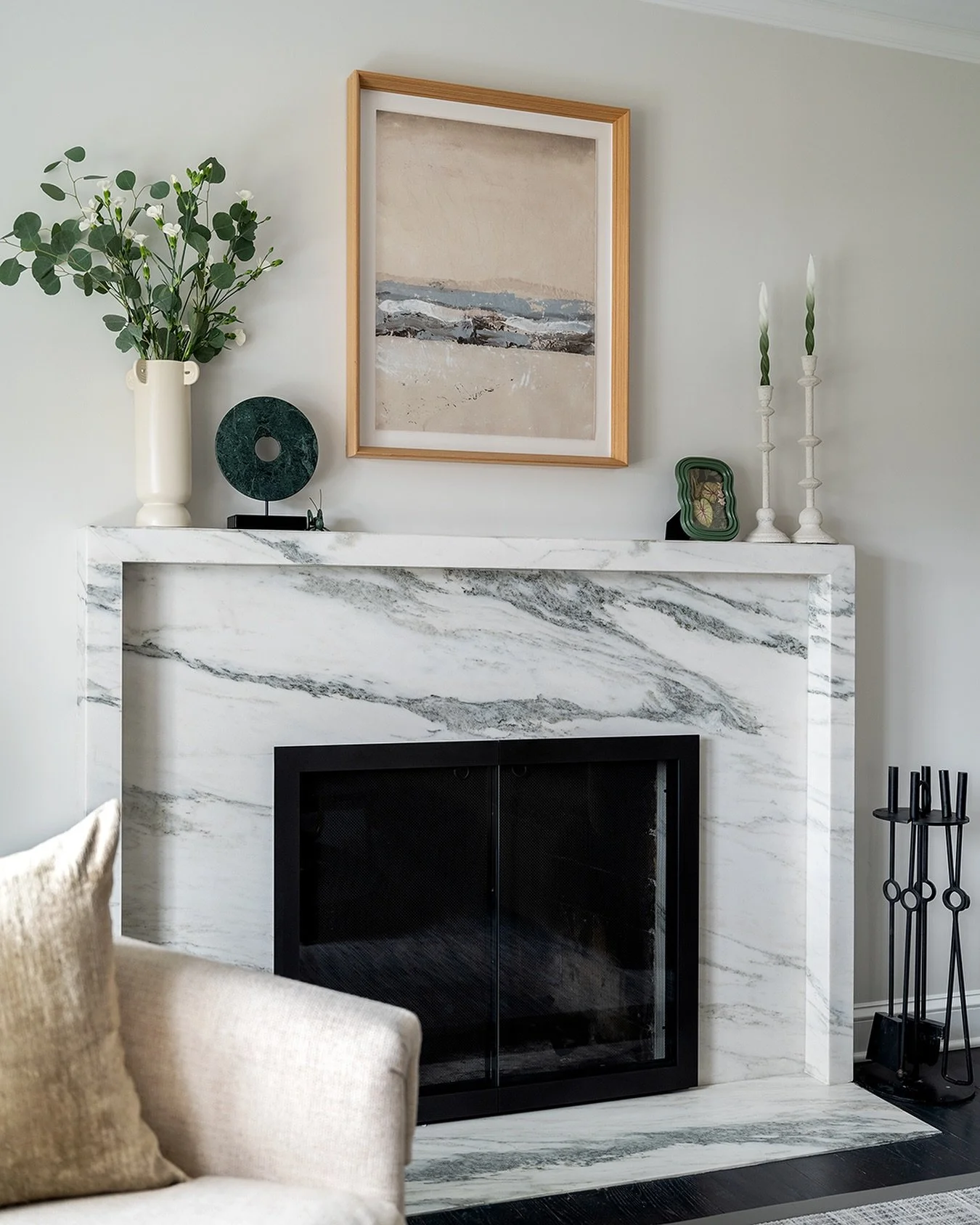 A fireplace glow-up. ✨

A stunning marble slab was paired with neutral wall art and accessories for the mantel. The custom black steel-and-glass doors help the veining in the marble to really pop. The fireplace became a show stopping focal point. 

P