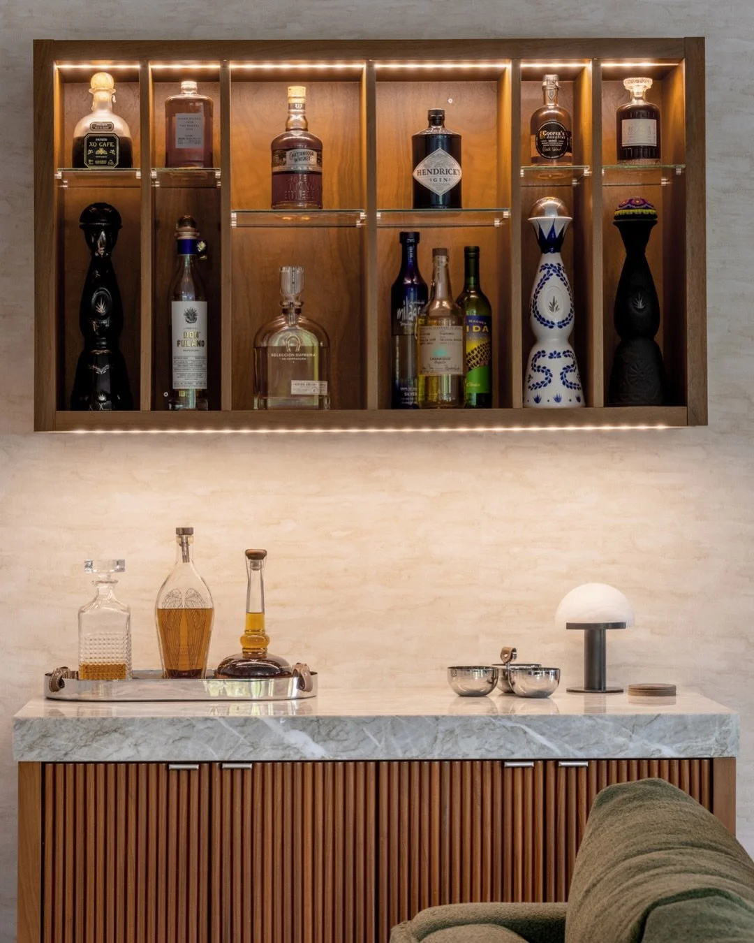 Here, custom millwork is the most elegant solution to a space planning challenge.

With the bar set along a main walkway and next to the artwork, designing a built-in allowed the family room to feel completely intentional.

The result is a piece that