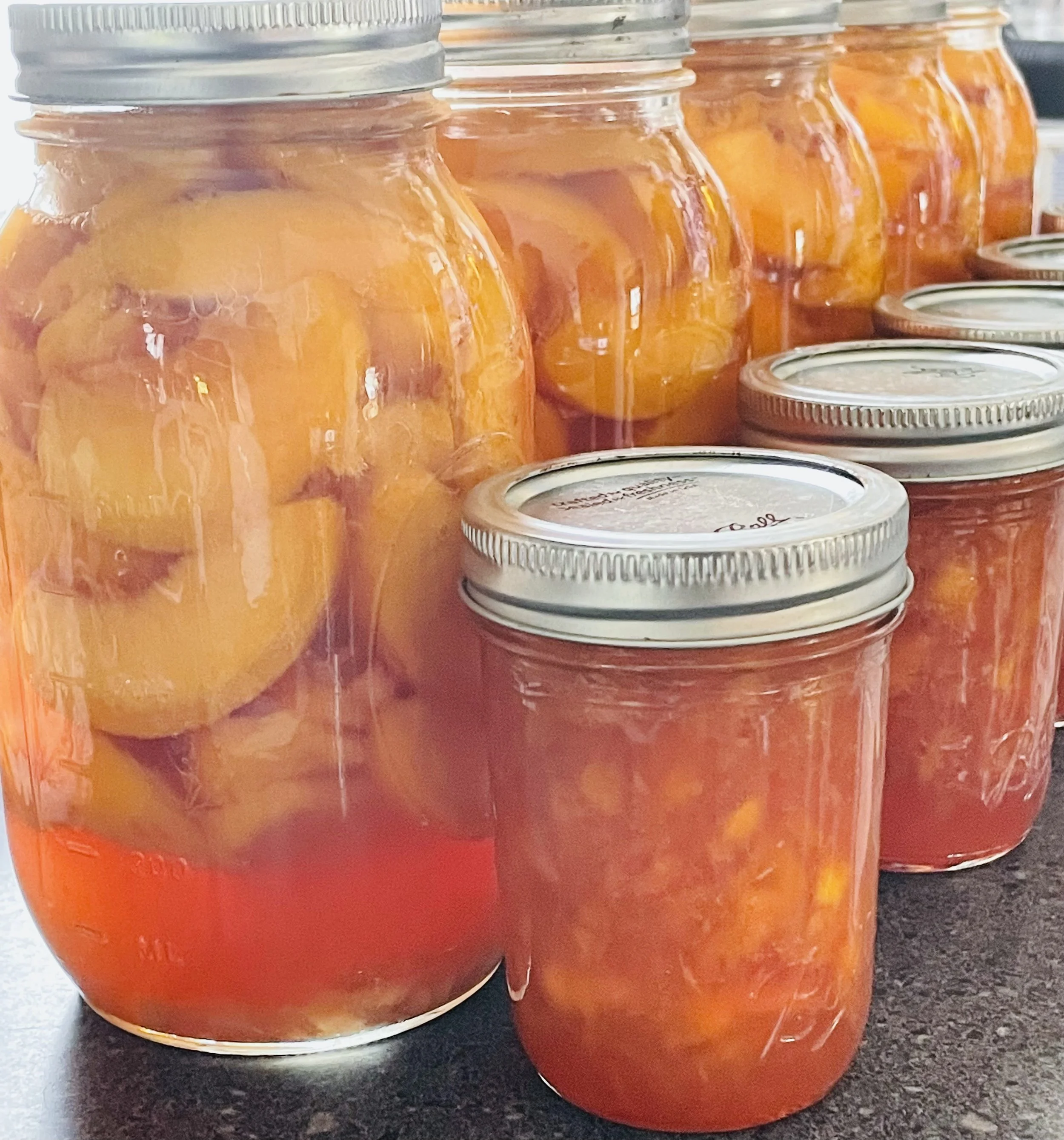 Last Season's Peach Jam And Jarred Peaches In Ginger Syrup