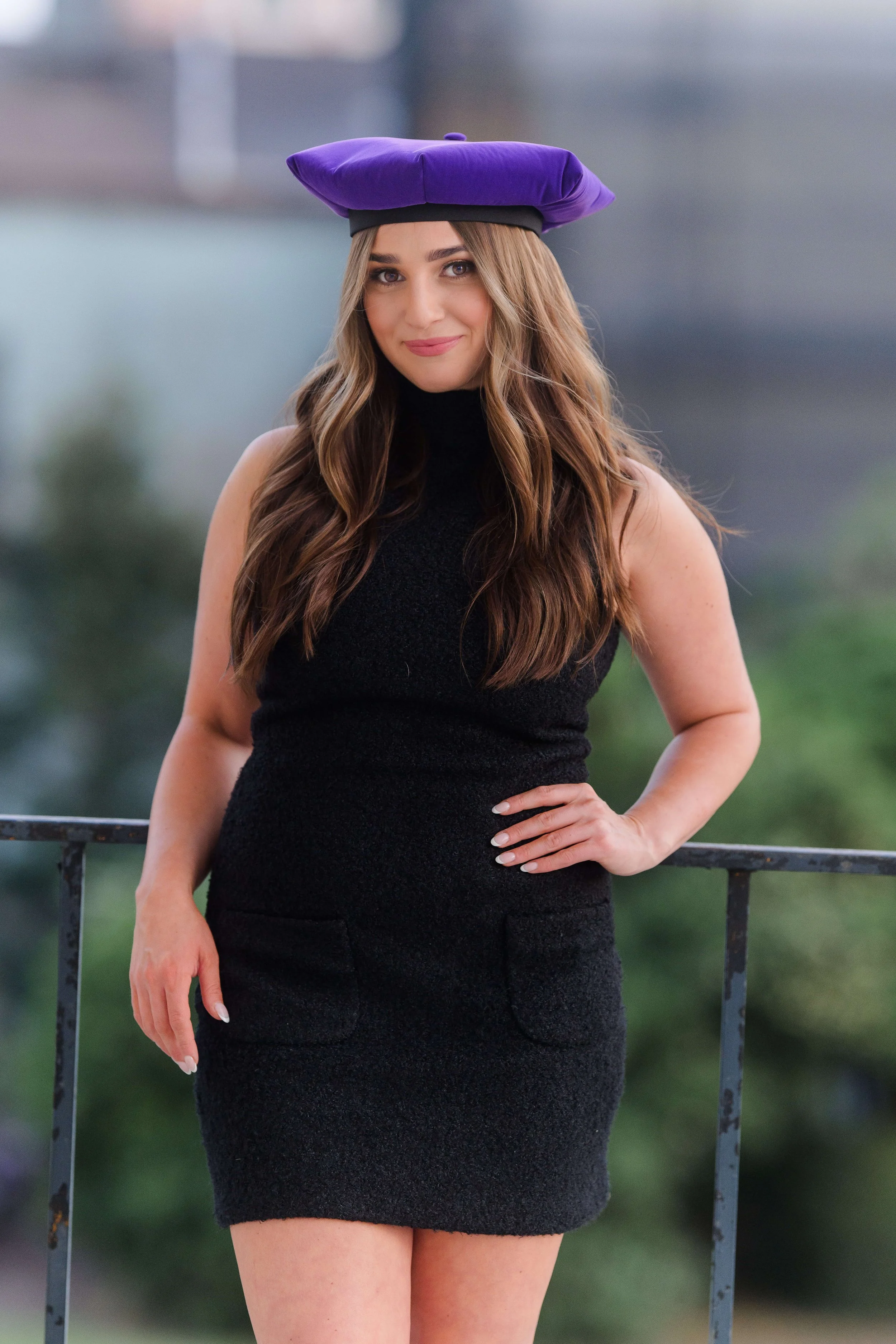 Charleston School of Law Grad Student in black dress and cap at US Customs House