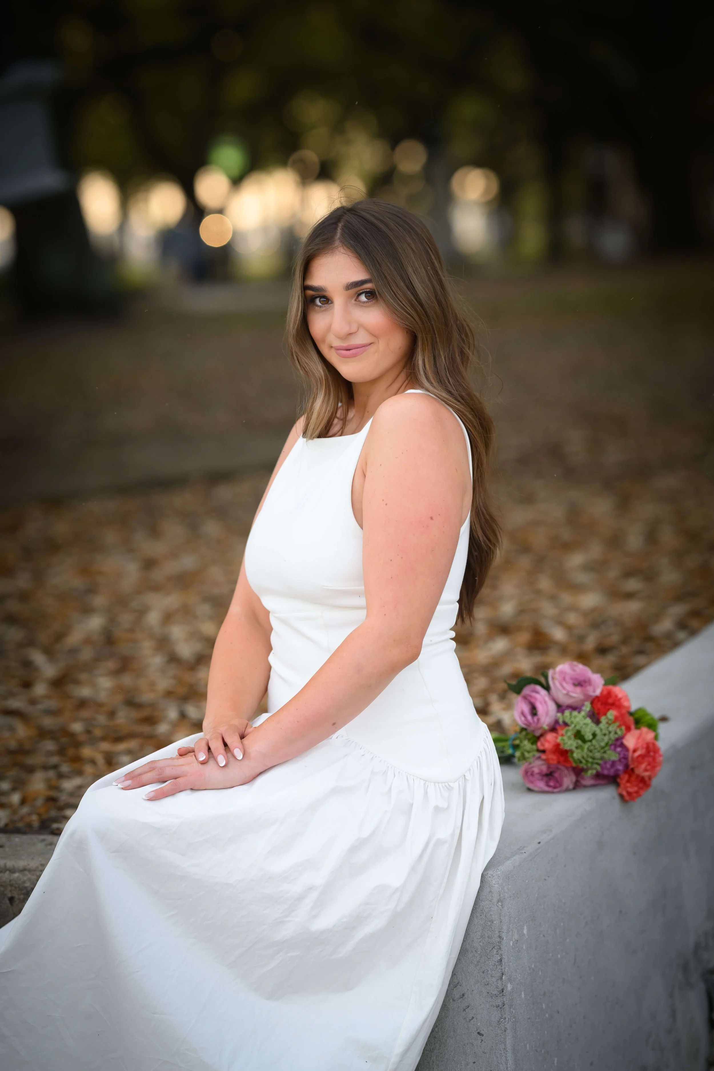 Charleston School of Law Grad Student sitting on cement wall at the Battery