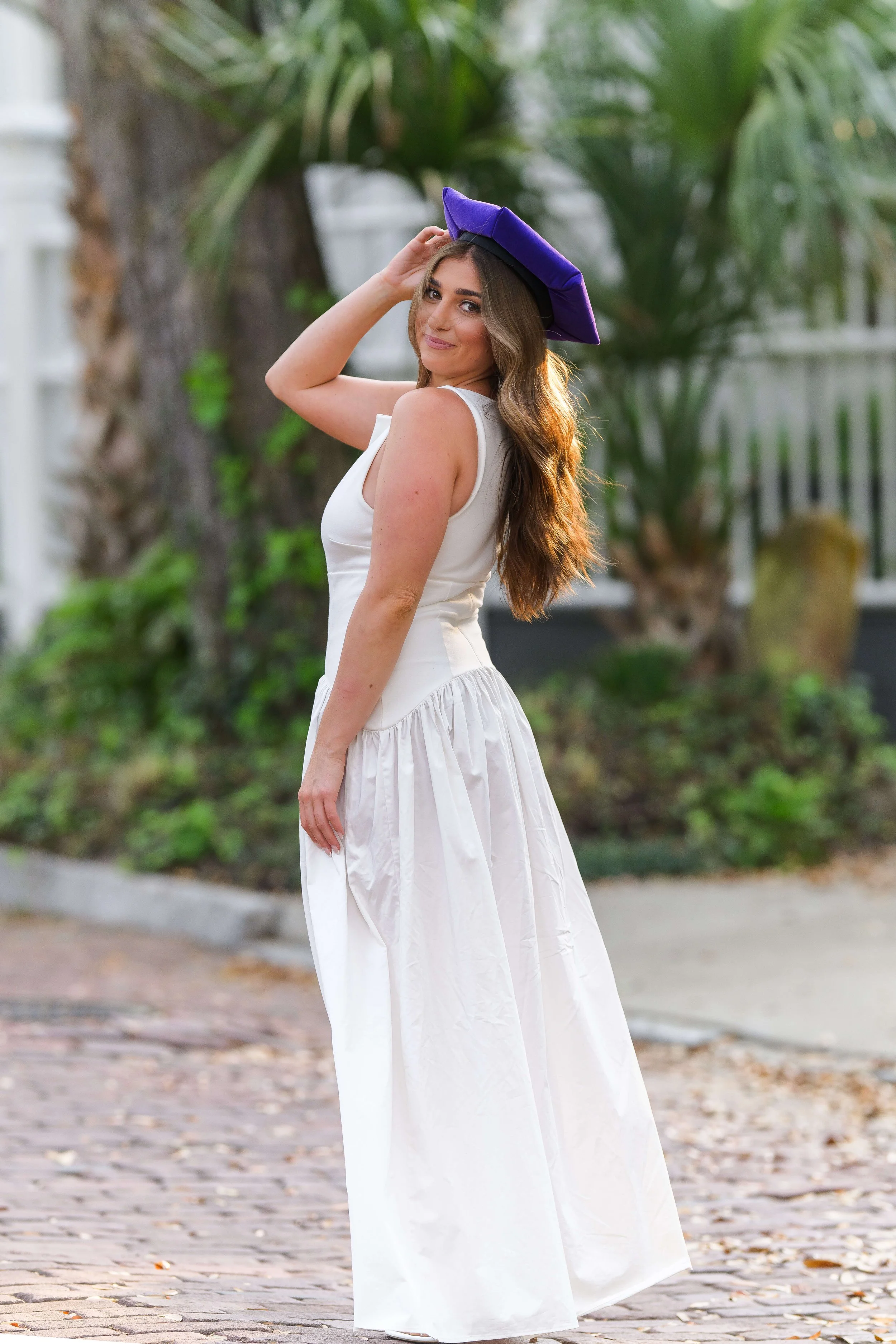 Charleston School of Law Grad Student in white dress and purple cap