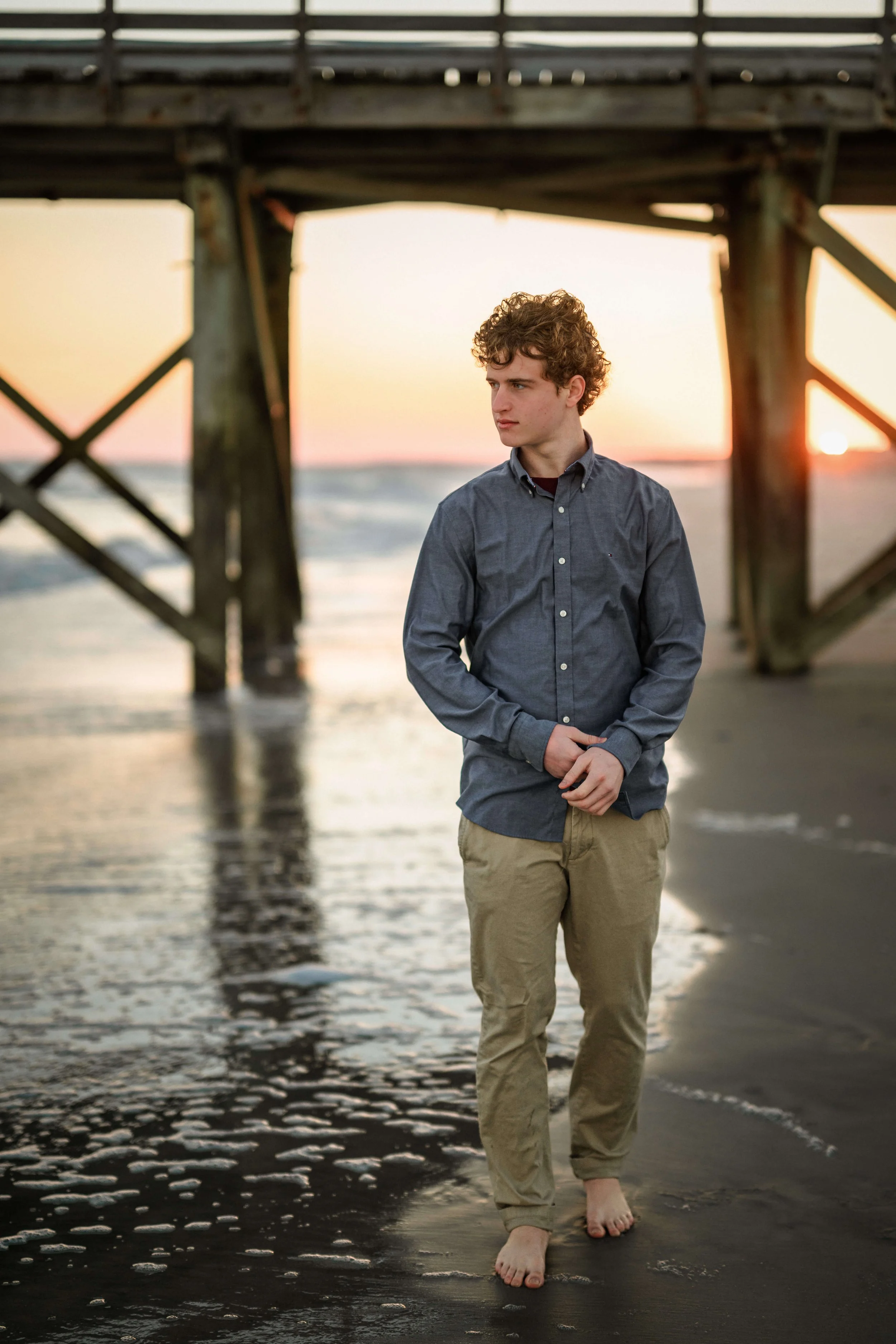 senior-portraits-boy-walking-beach-isle-of-palms.jpg