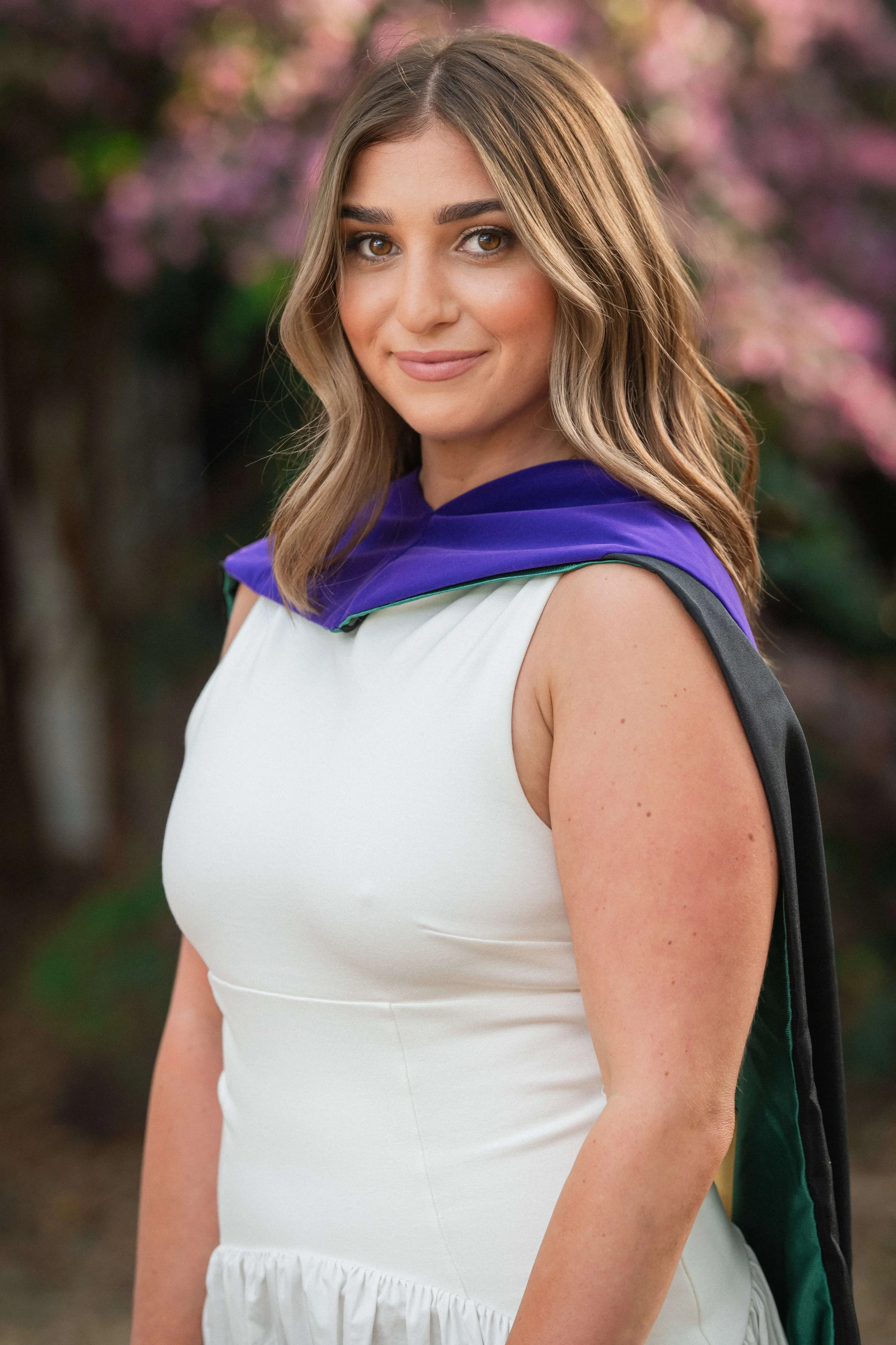Charleston School of Law Grad Student close-up in white dress and hood