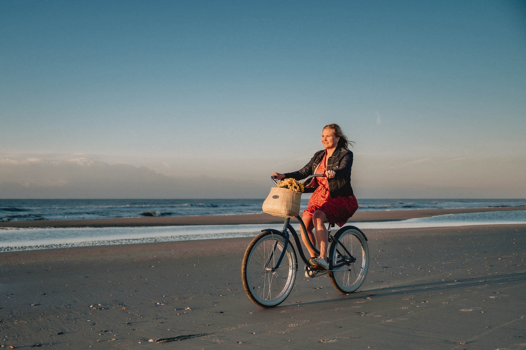 woman-on-bike-sunrise-beach.jpg