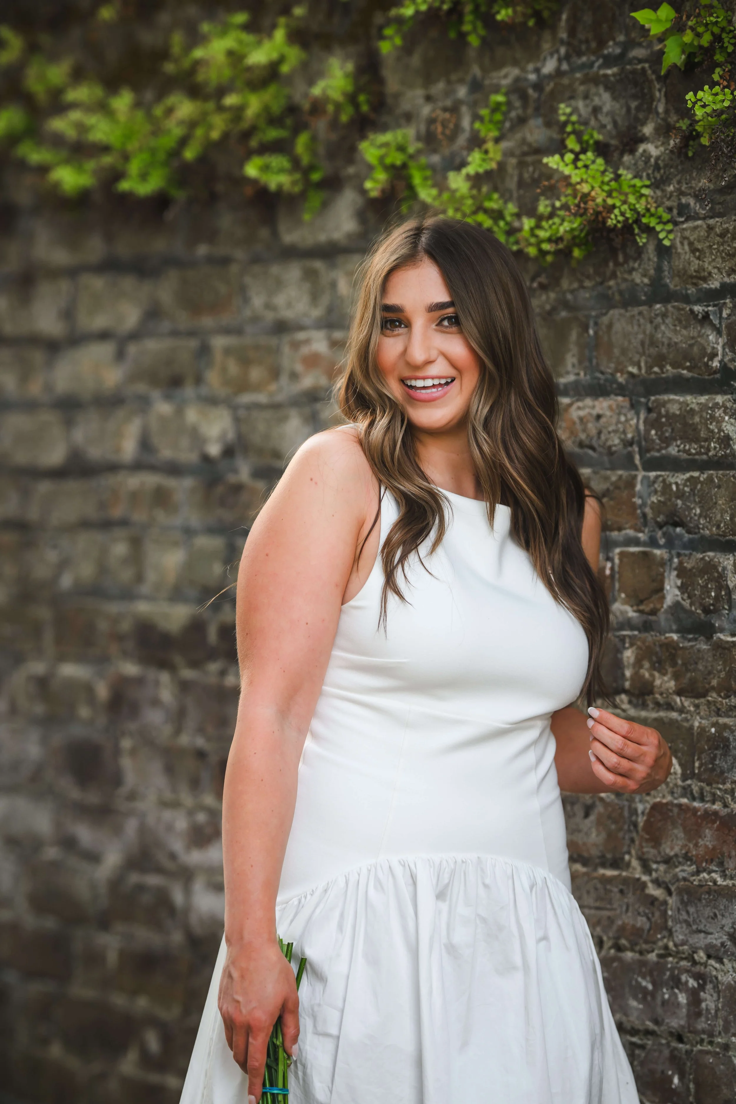 Charleston School of Law Grad Student smiling at camera in white dress