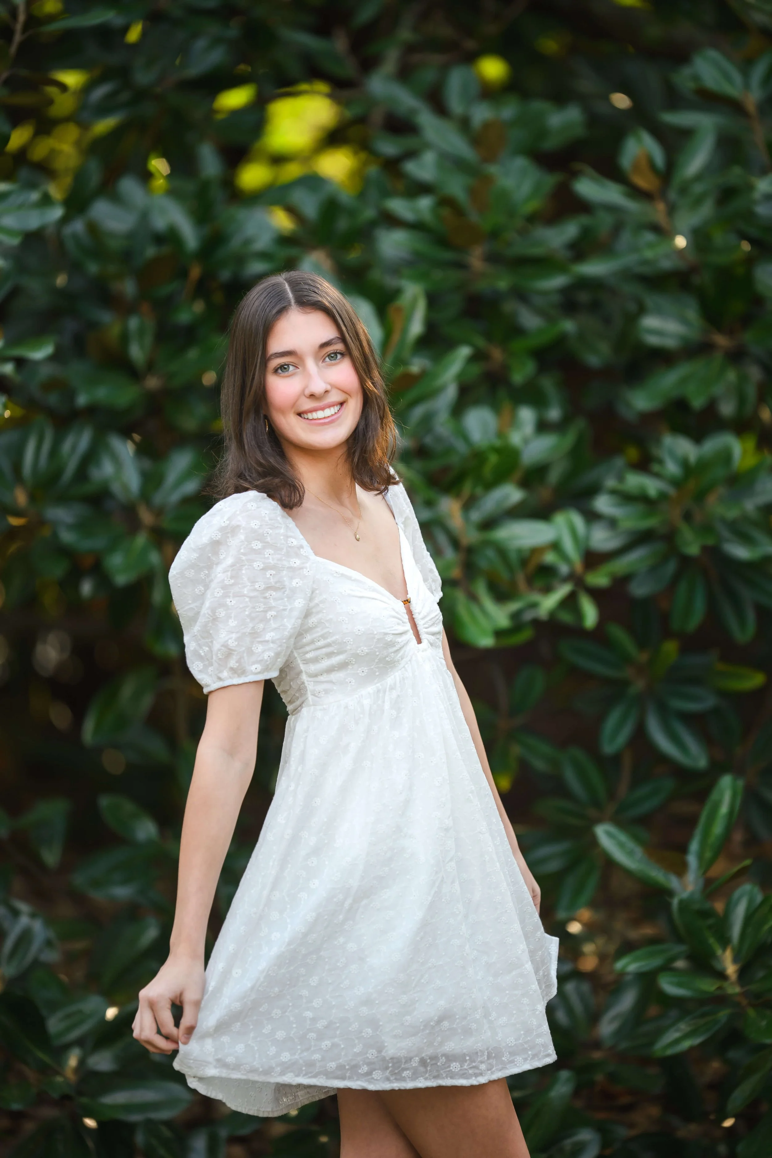 girl posing with large magnolia tree in background at Hampton Park in Charleston