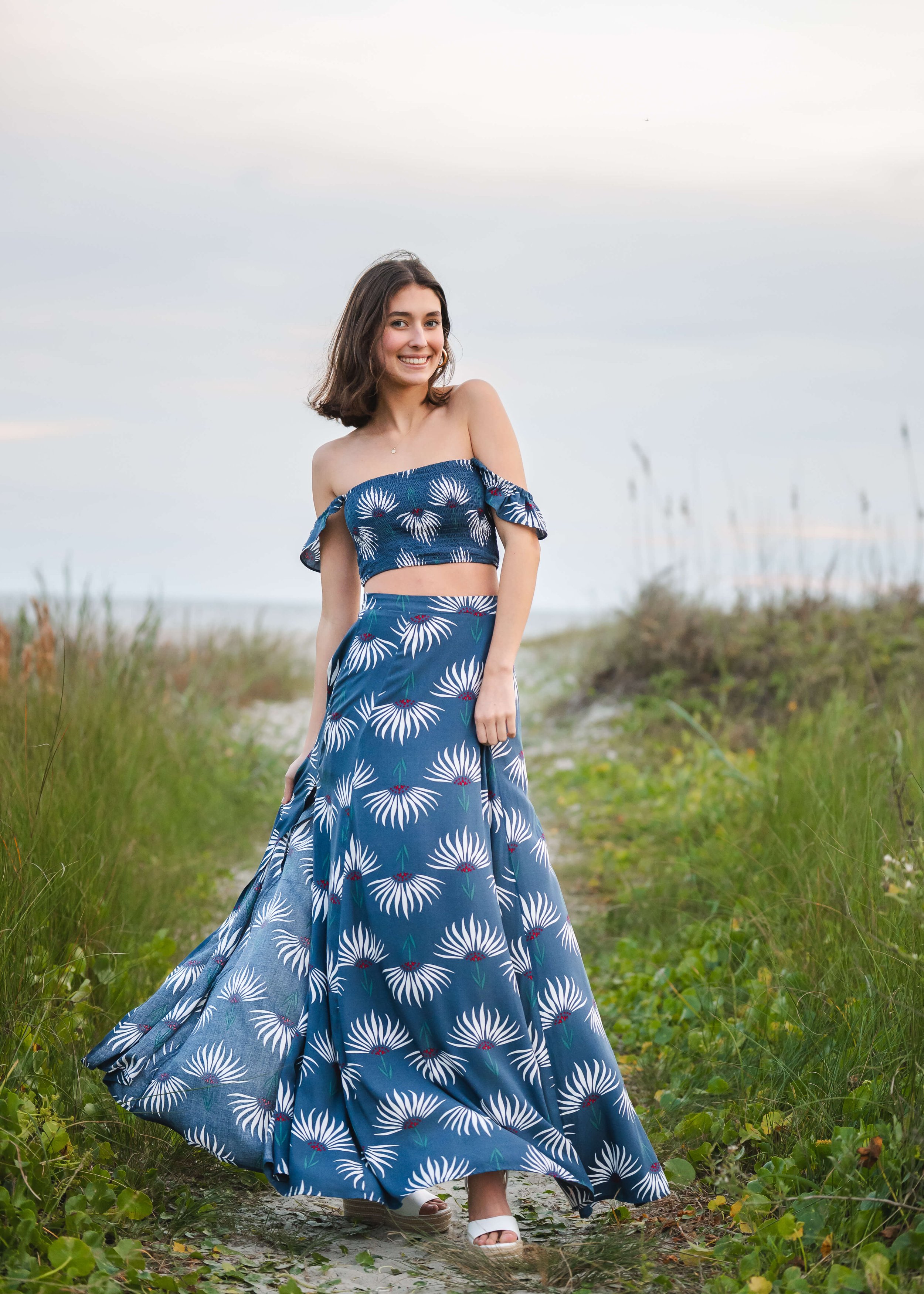 IOP beach girl posing for senior photos in blue skirt and top.
