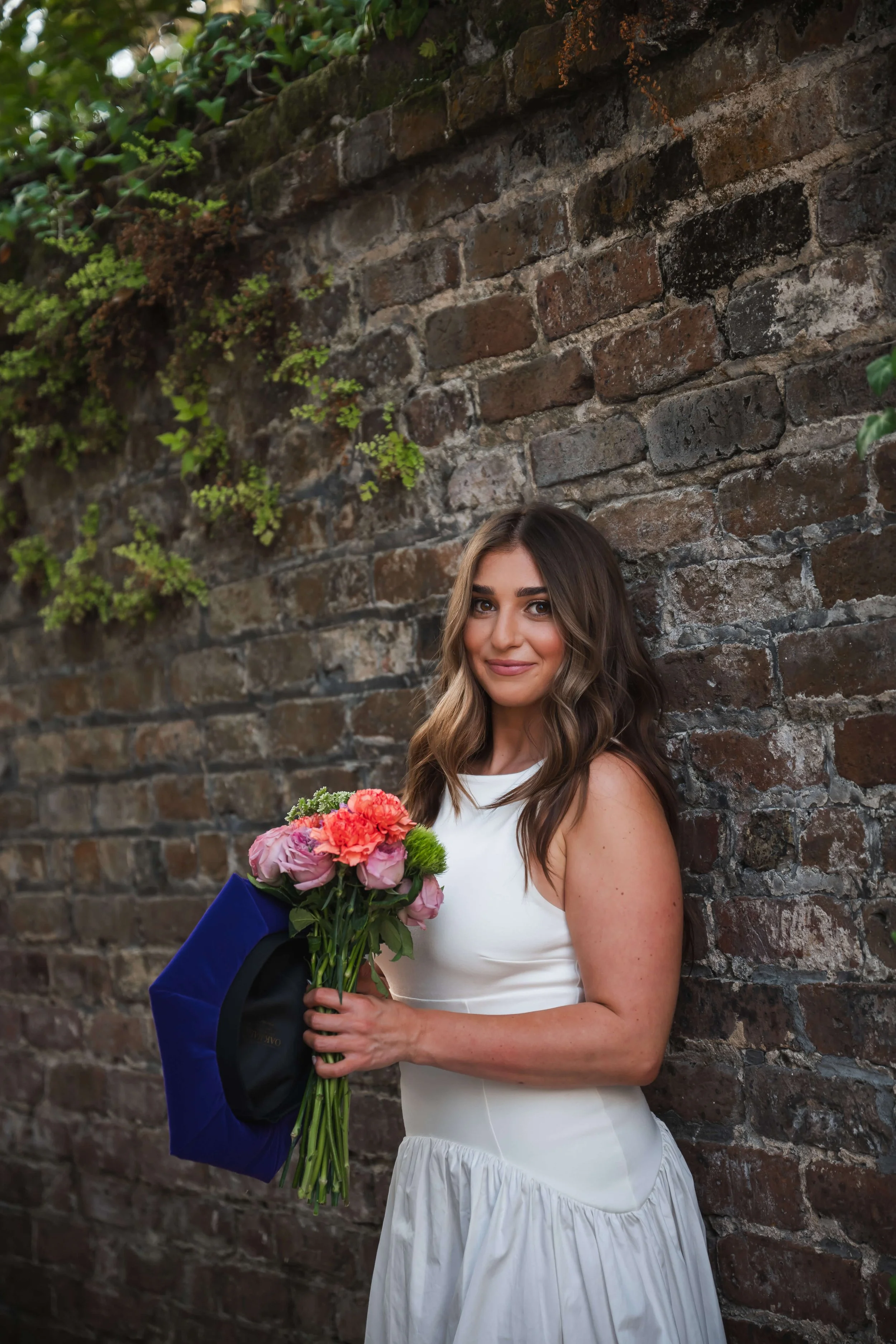 Charleston School of Law Grad Student leaning against a brick wall
