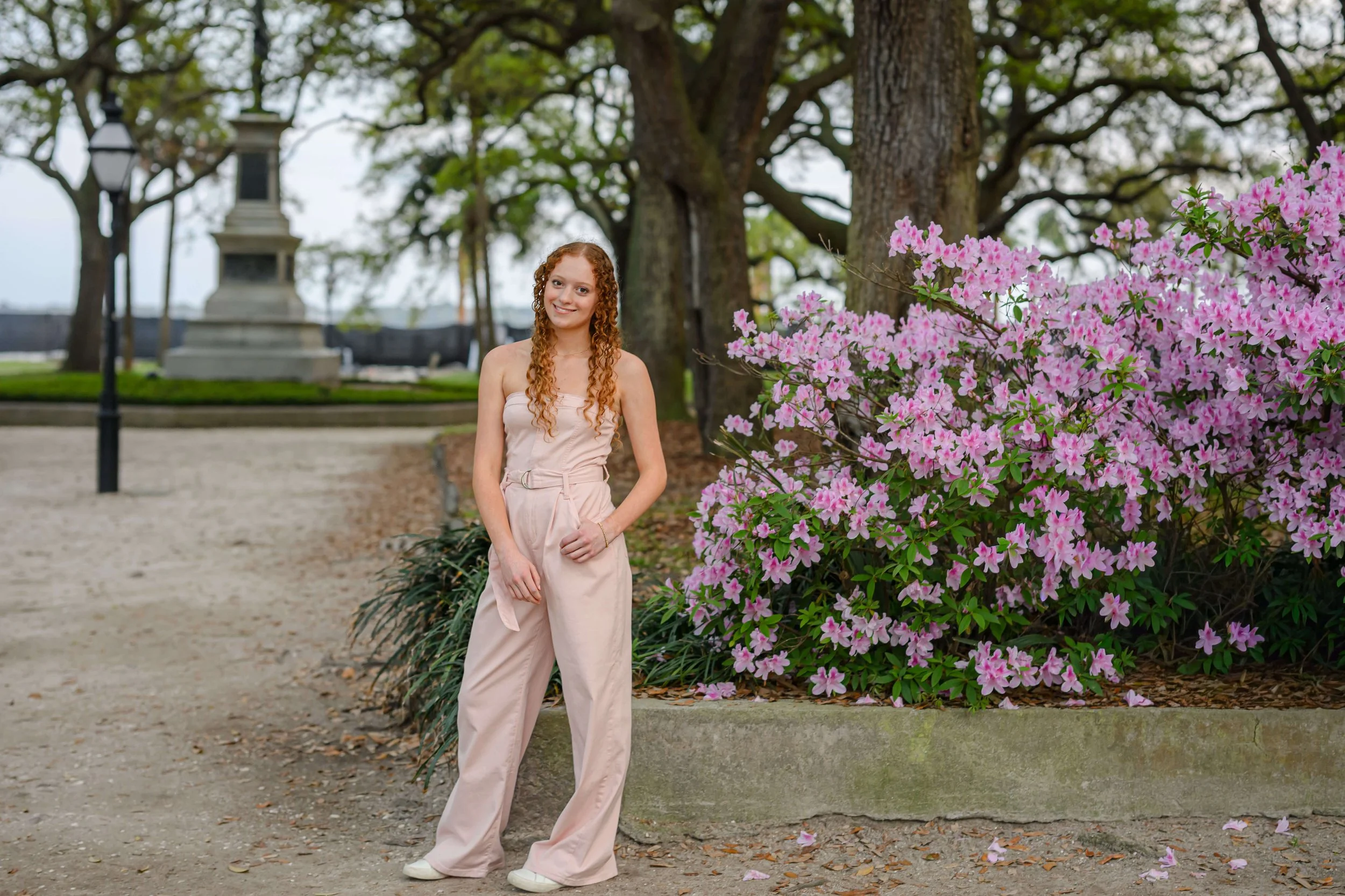 Senior portrait with purple azaleas at White Point Garden Charleston