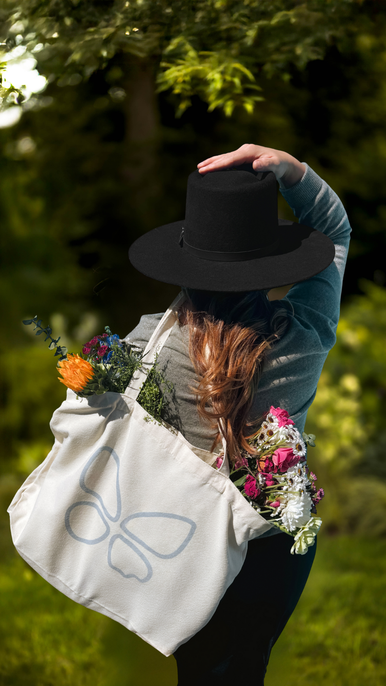 Be Present Not Perfect tote in the garden