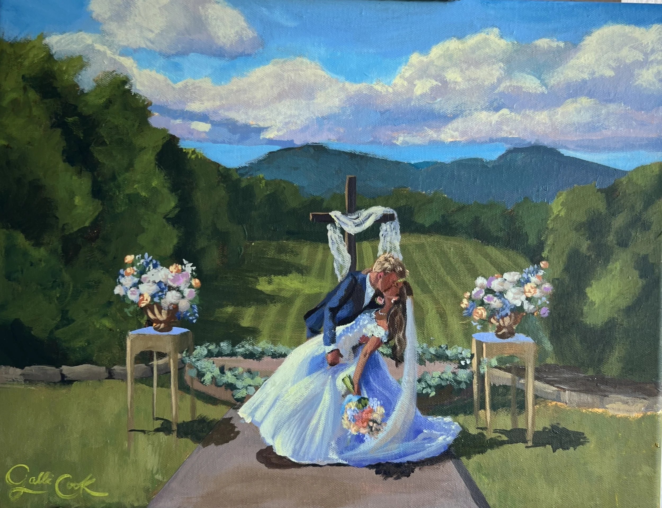 Painting of a wedding ceremony outdoors with a groom kissing a bride in front of a wooden cross, mountains and trees in the background, and flowers on side tables.