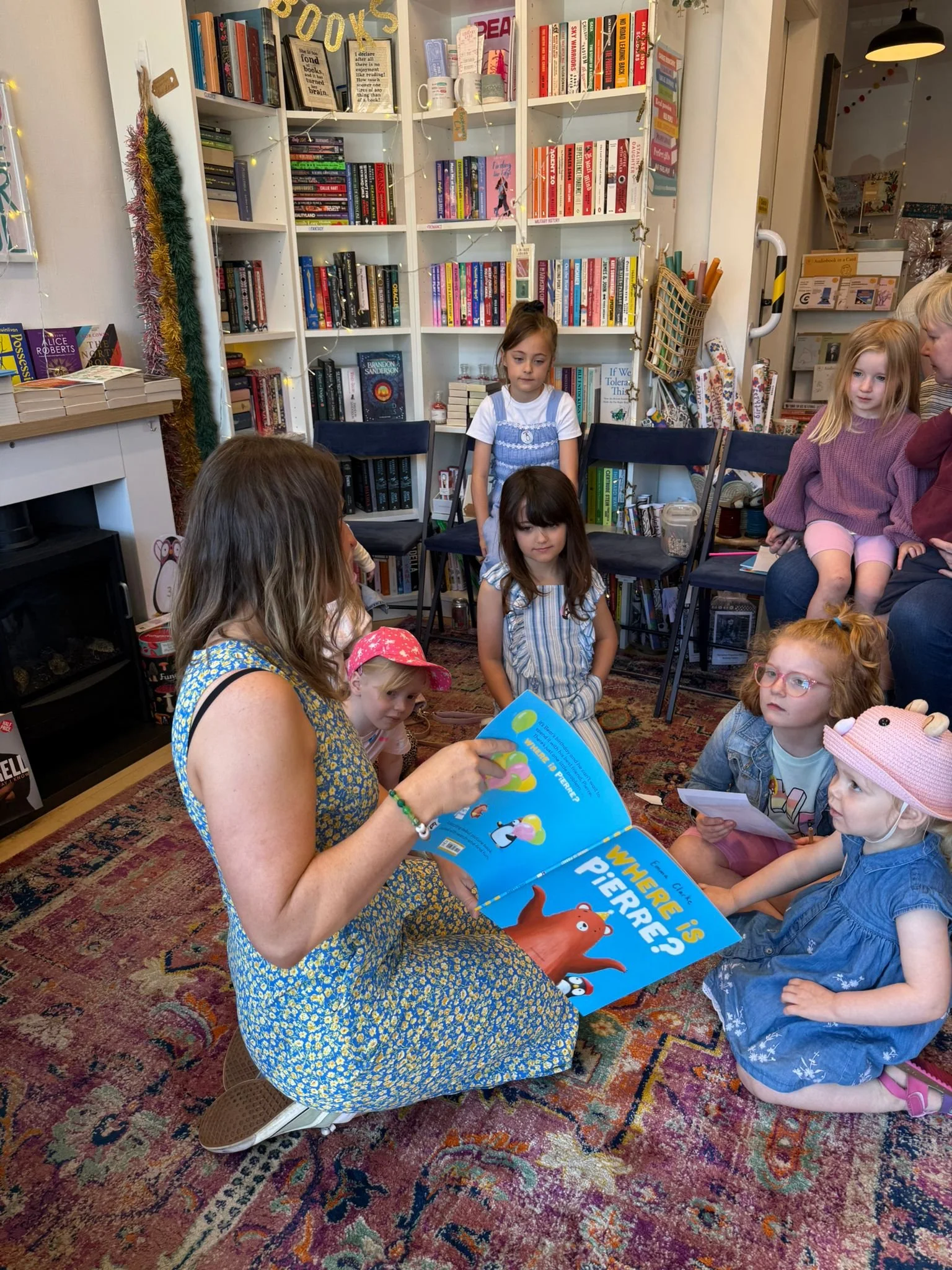 Children's author and illustrator Emma Clarke reading 'Where is Pierre?' to young children at a bookshop event.