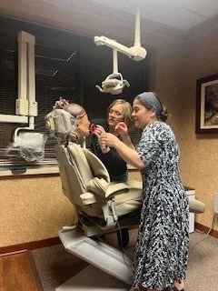 Jen demonstrating ideal bitewing positioning at Lake Country Periodontics and Implant Dentistry.