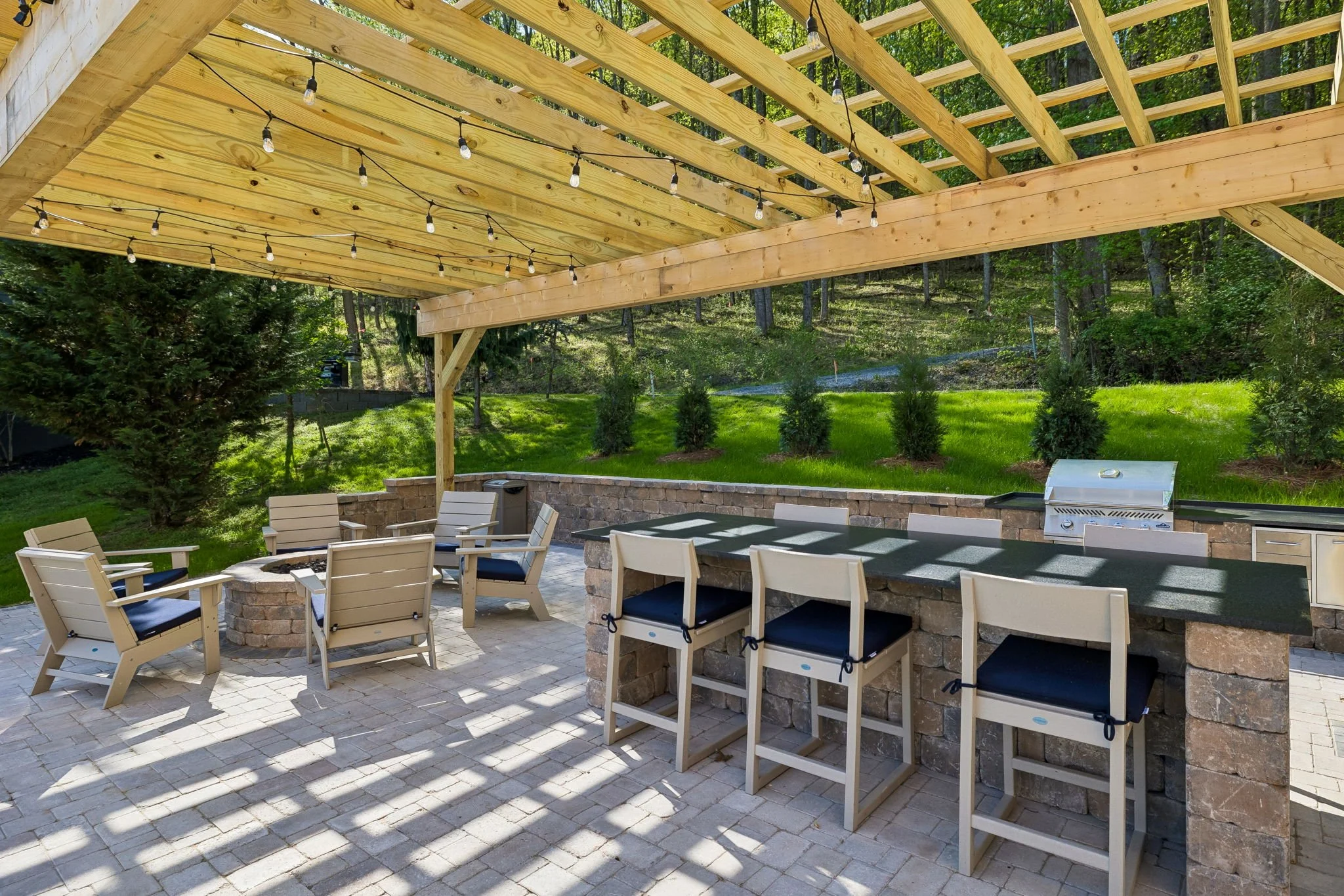 Every Airbnb has a bedroom. Not every Airbnb has this.
We built the whole package &mdash; pergola, paver patio, outdoor kitchen, island, fire pit, retaining wall &mdash; because the outside of a rental property is just as bookable as the inside.
The 