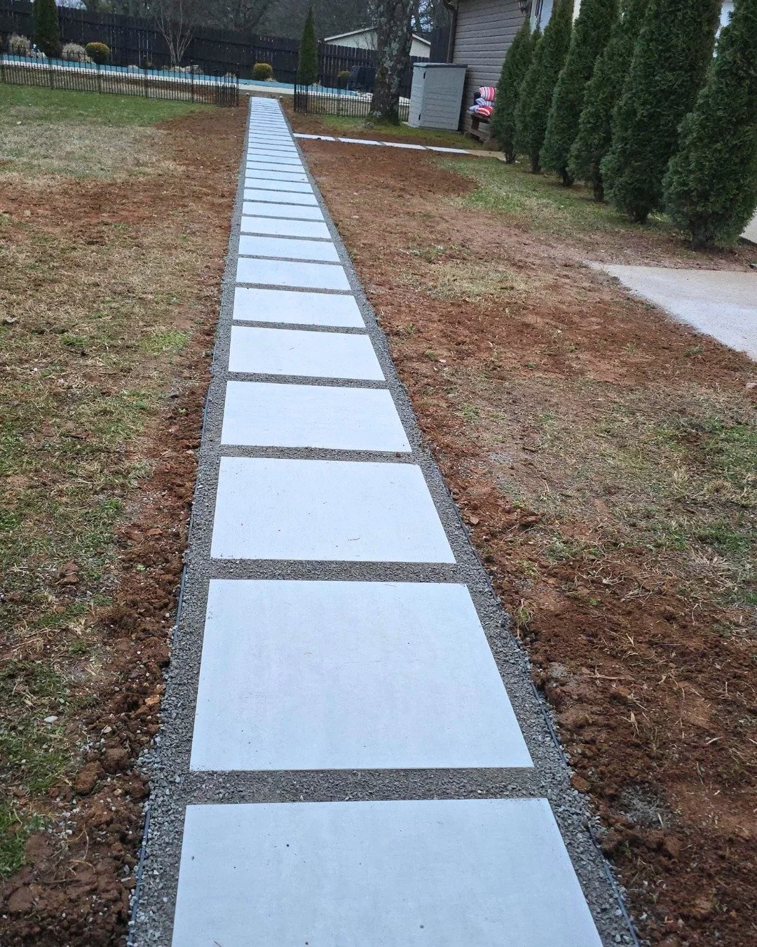 A path should know where it's going.
Clean lines. Concrete pavers. Crushed stone joints. No guessing, no wandering.
This is what intentional looks like from the driveway to the pool.