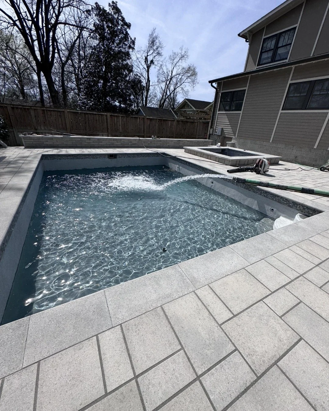 Downtown Nashville doesn't exactly hand you a sprawling backyard, which means when we design in these lots, every single square inch has to pull its weight.

This one fits a pool, hot tub, outdoor kitchen, turf, and ambient lighting into a space that