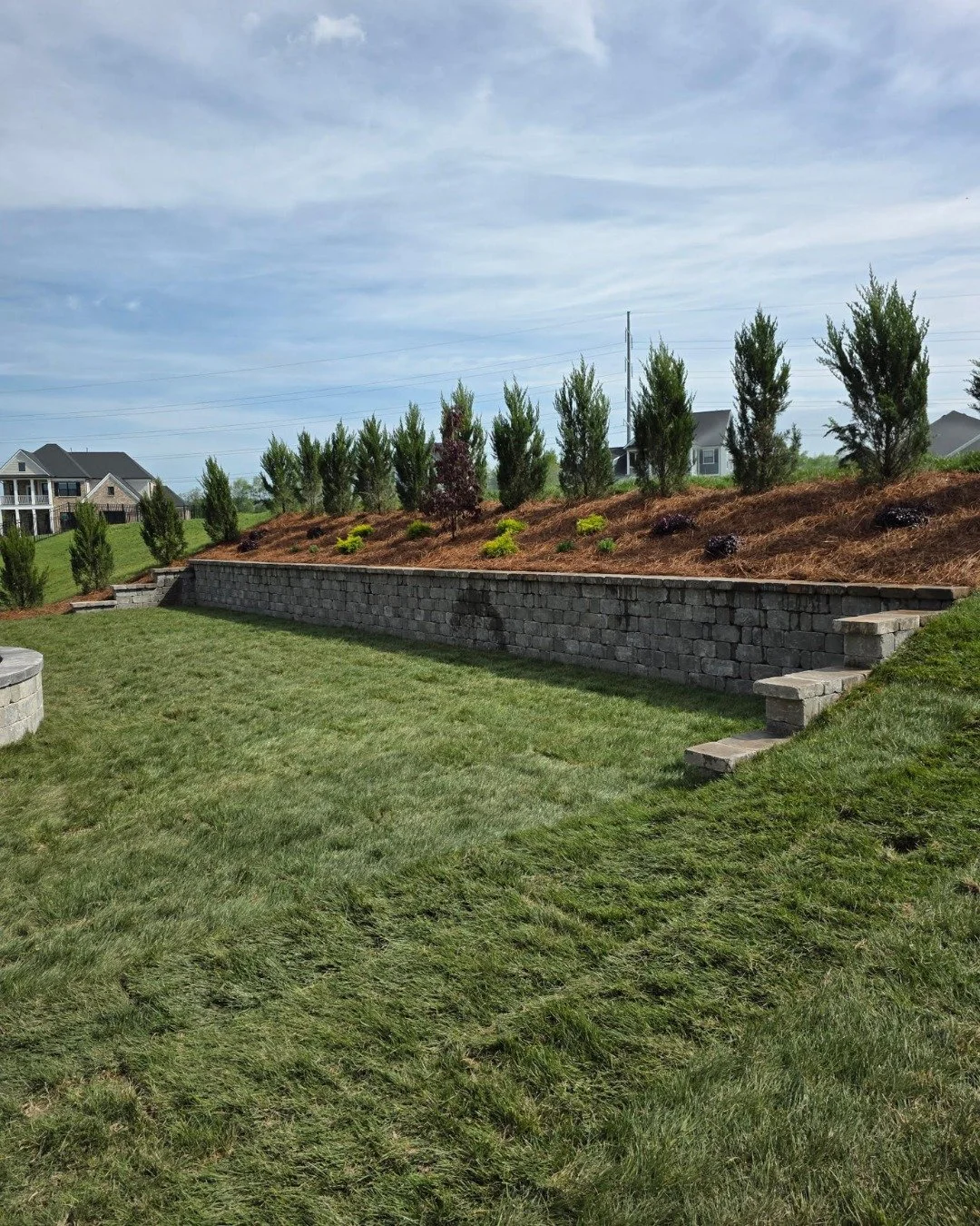Middle Tennessee is hilly. That's just the reality. But a slope isn't a dead end &mdash; it's a design problem, and design problems have solutions.

A well-built retaining wall does three things at once: it reclaims usable land that a hill was steali