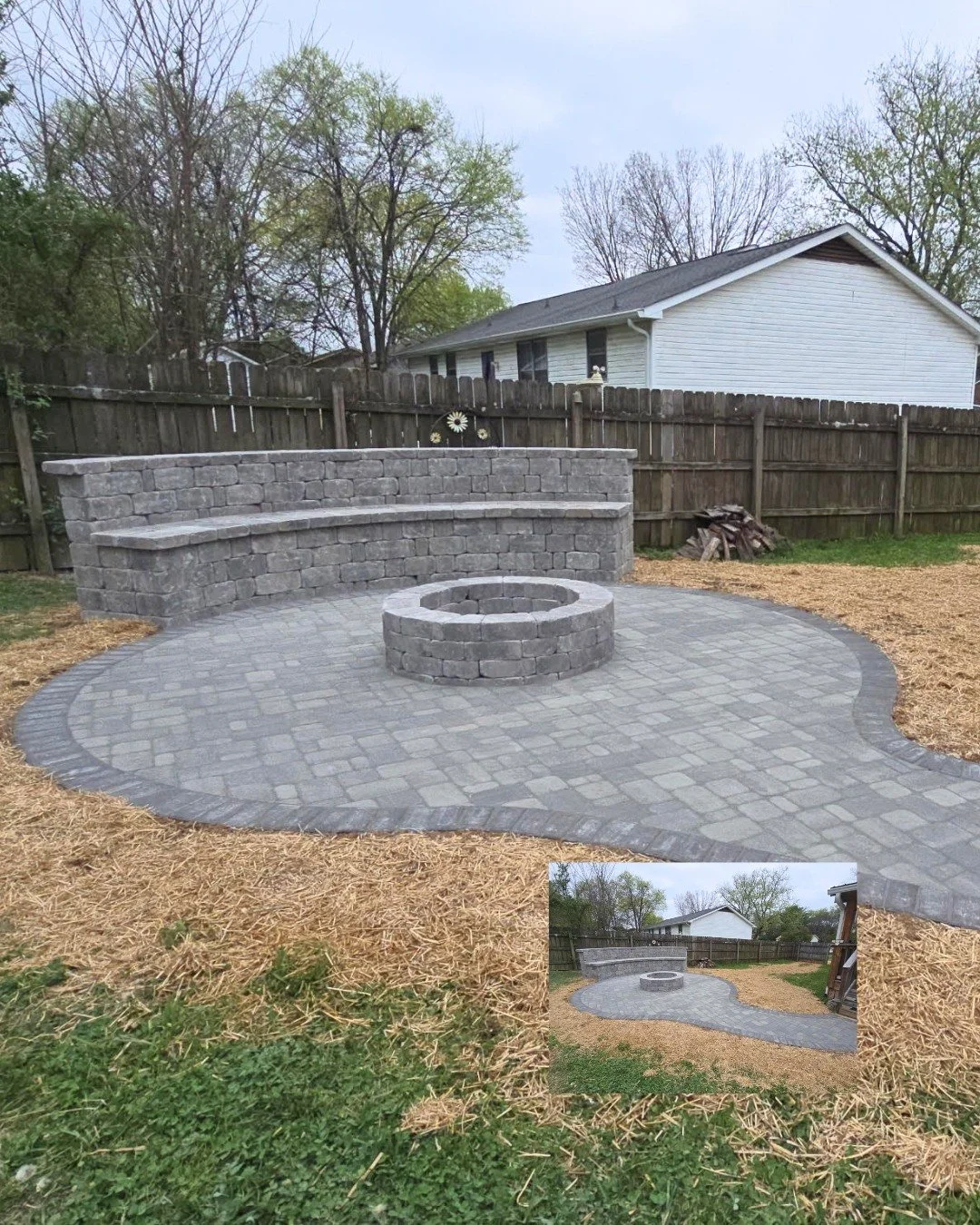 Dragging chairs across the yard every time you want to sit around a fire is nobody's idea of a good time.

Built-in seating wall. Circular fire pit. Pavers that flow straight off the main patio. Everything where it needs to be before the first person