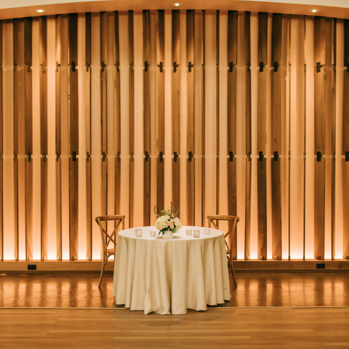 The perfect space for a sweetheart table. Facing the dancefloor, with our custom wood paneled wall as the backdrop.​​​​​​​​​
Photographer: @catherineleighphoto
Associate Photographer: @lauramemoryphotography
Bar Cart: @cloudbydaycreations 
Planner: @