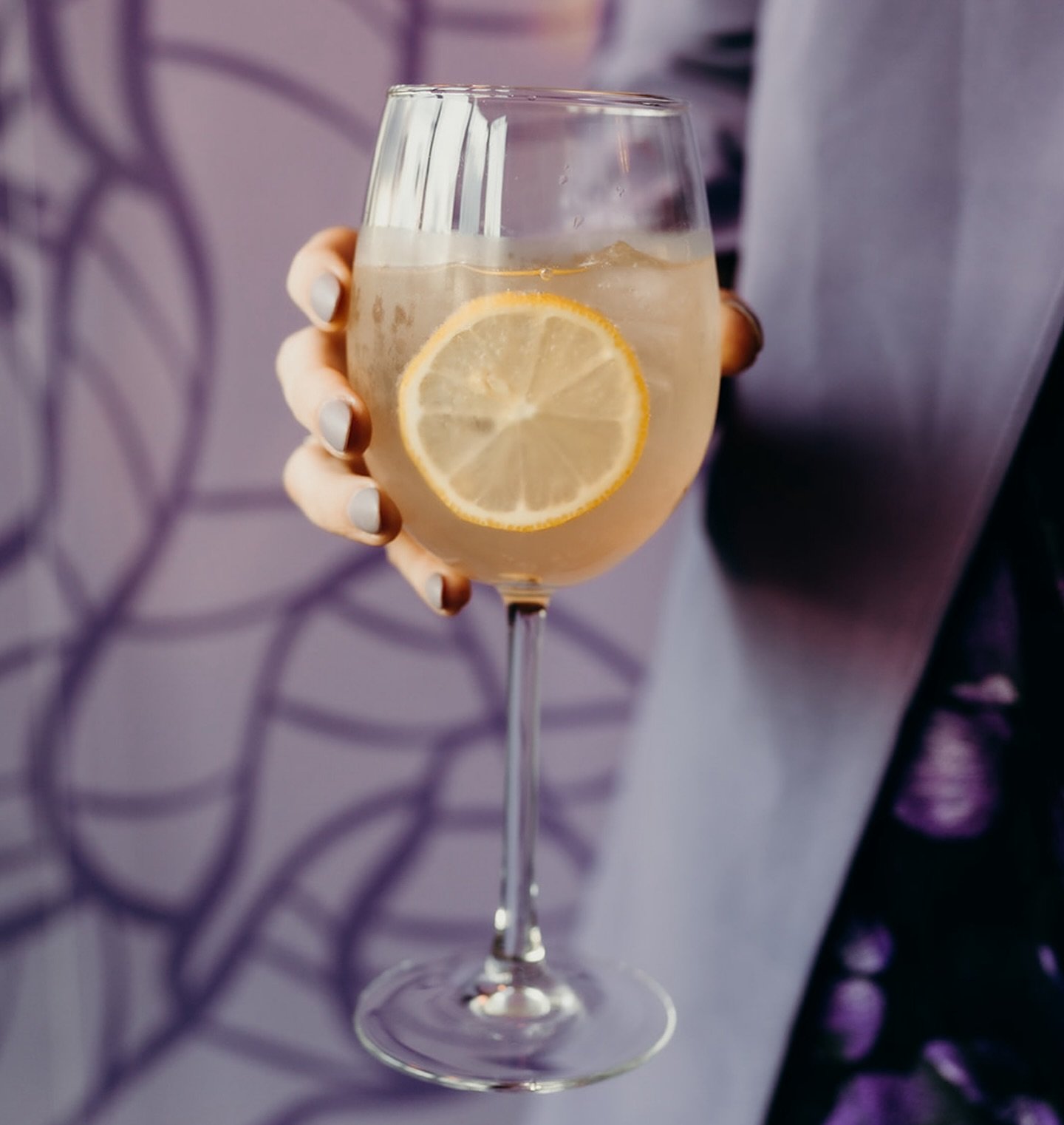 Sippin&rsquo; in style with our Lavender French 75 &mdash; floral, fizzy, and finished with a twist of lemon. || The perfect signature cocktail to elevate any event! 

#foodandbeverage #eventcatering #cocktails #customcocktails #french75 #craftcockta
