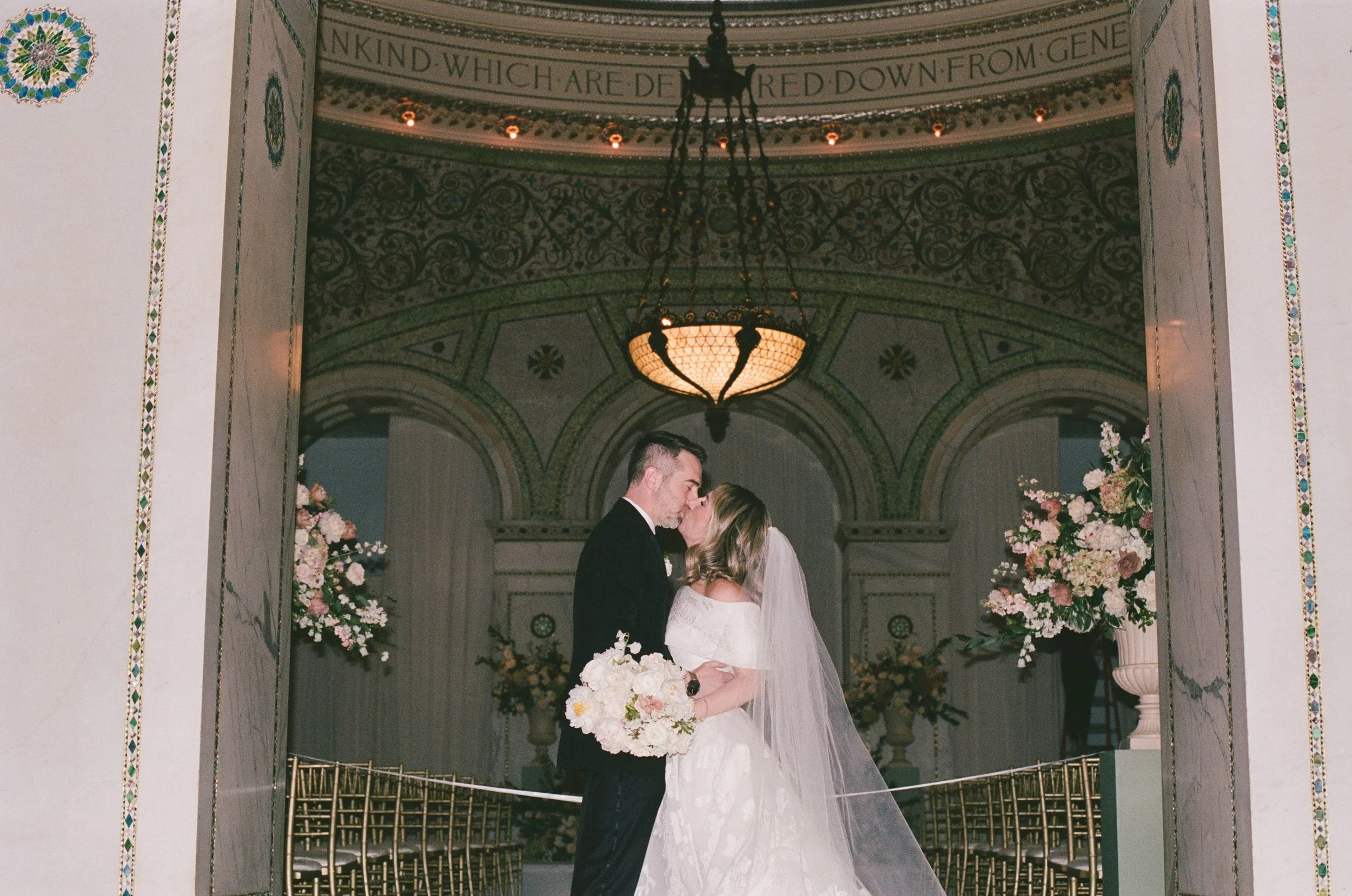 Bride and groom kiss on film at Chicago Cultural Center wedding
