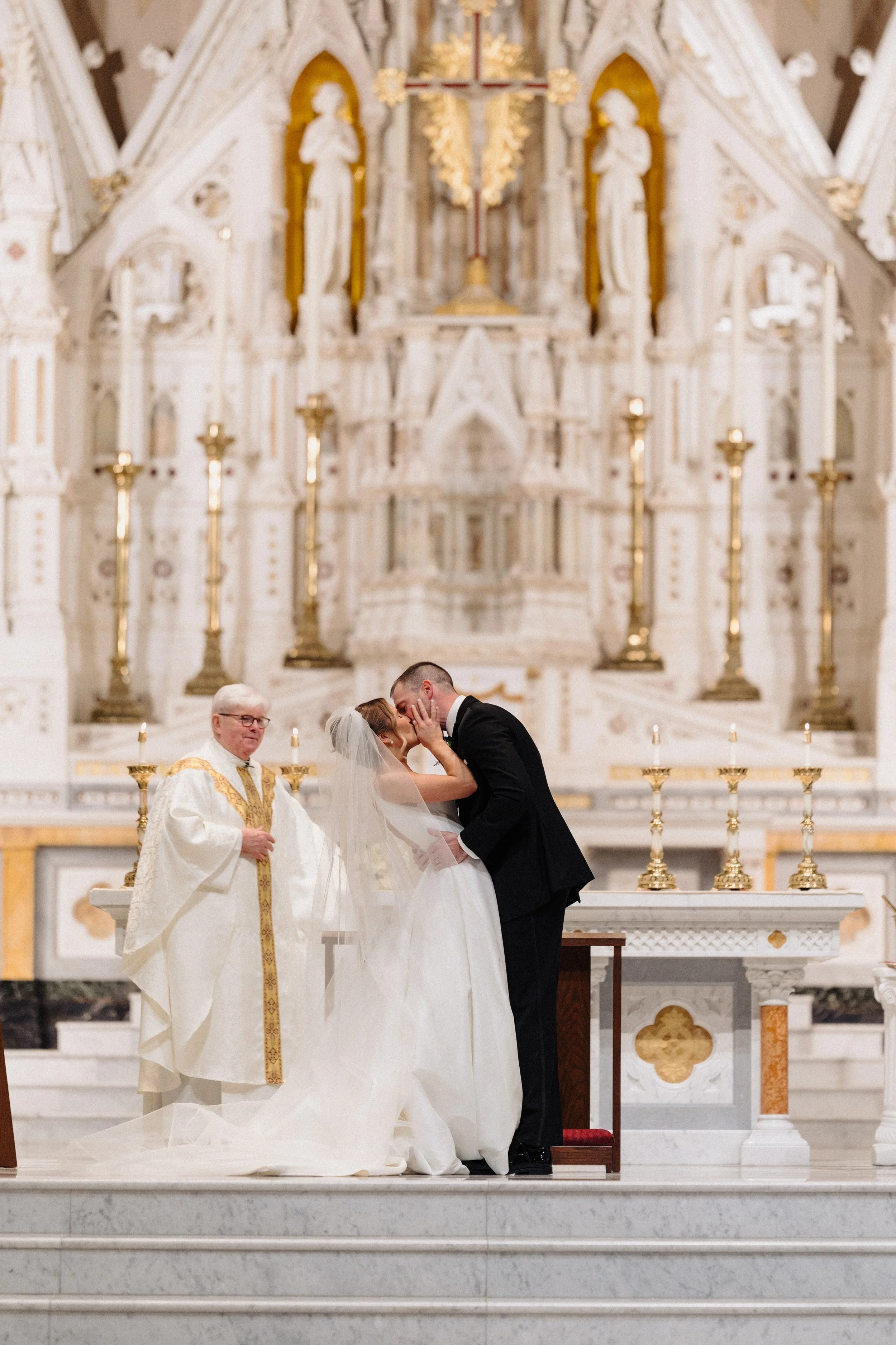Bride and groom kiss at their Cathedral of the Holy Cross wedding ceremony in Boston