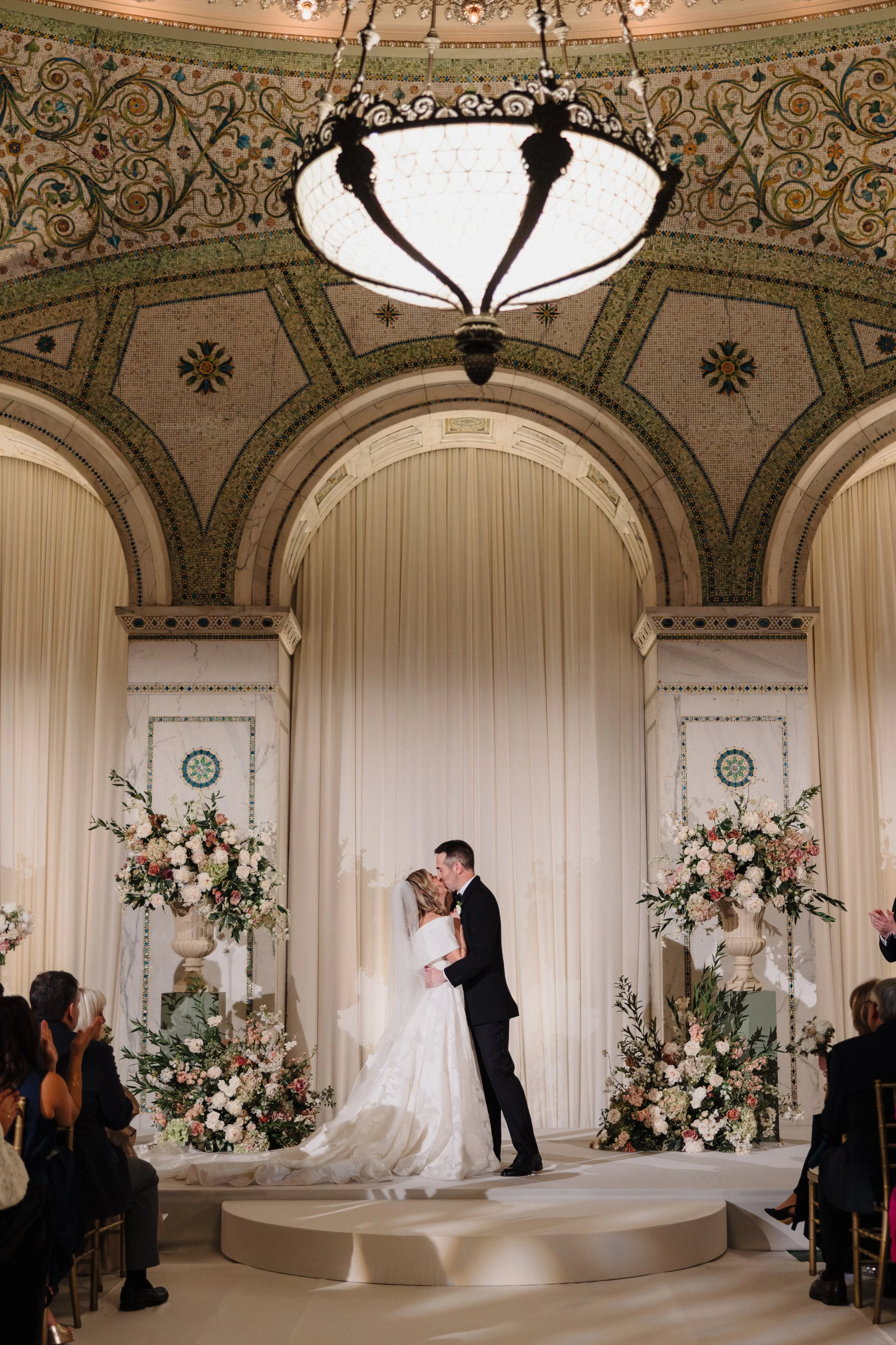 Bride and groom kiss at their Chicago Cultural Center wedding ceremony