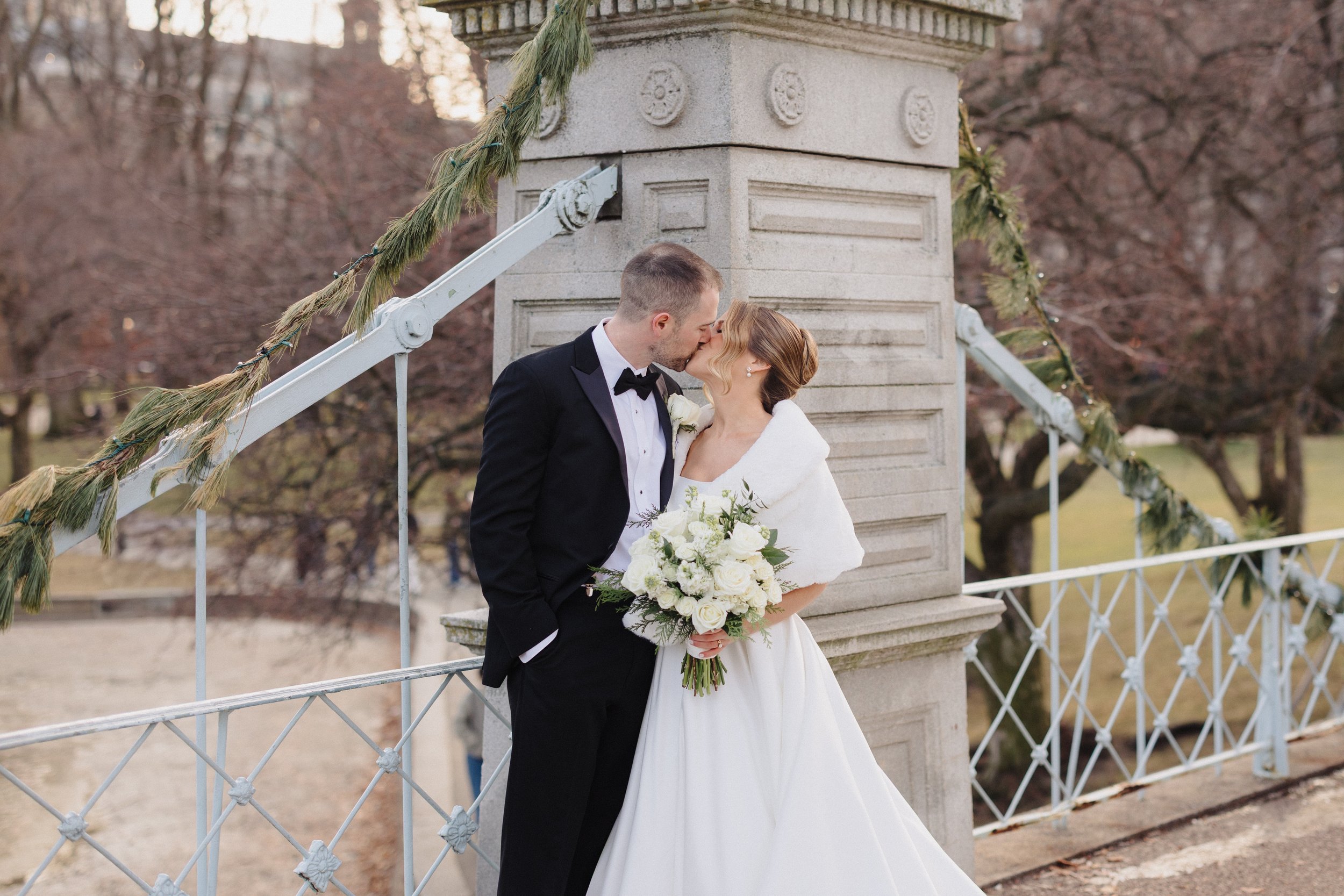 Couple kiss in the Boston Public Garden at their Back Bay wedding