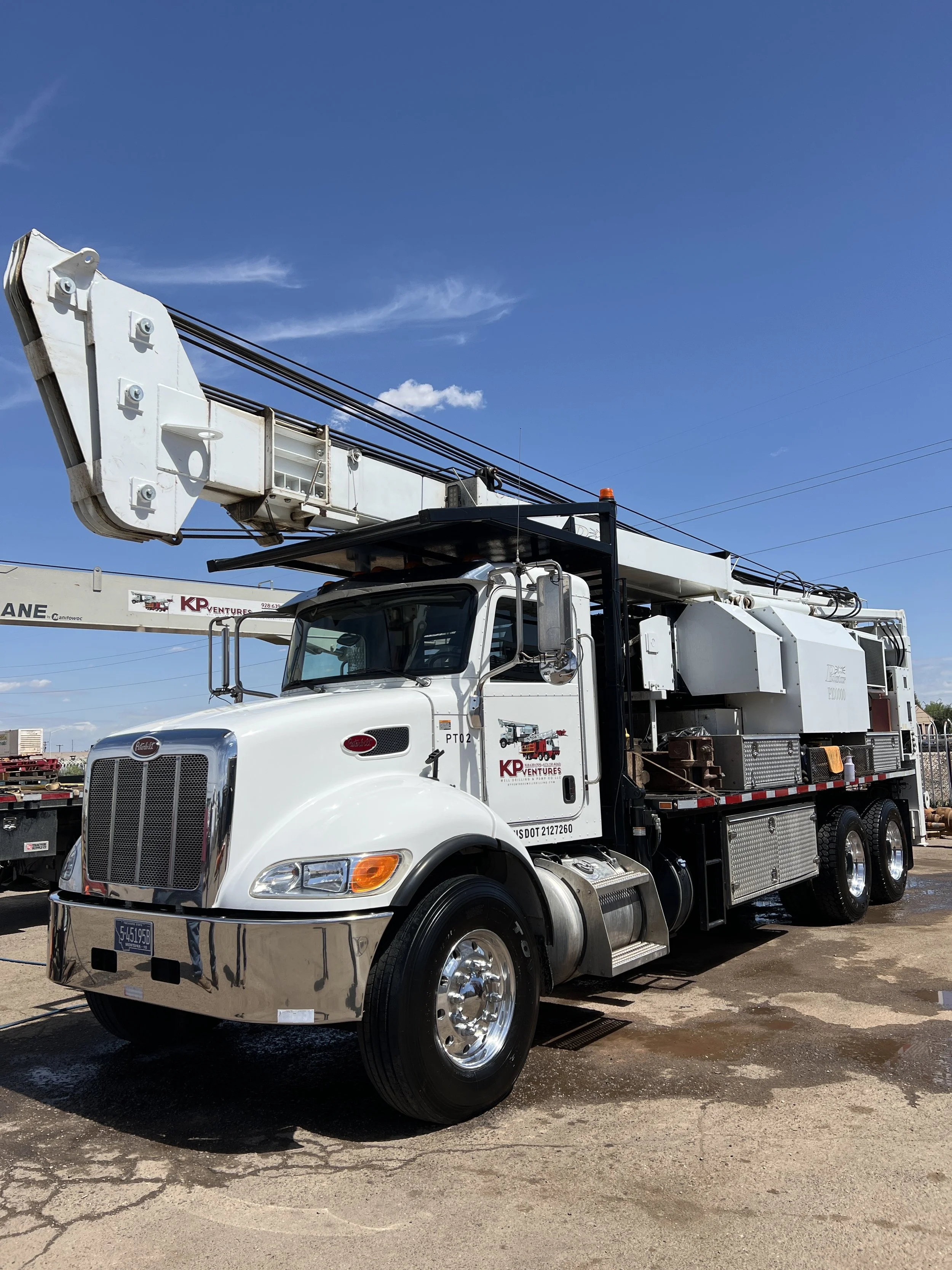 Commercial water well drilling fleet and support trucks at the KP Ventures yard, showcasing equipment for municipal, industrial, and commercial groundwater projects.