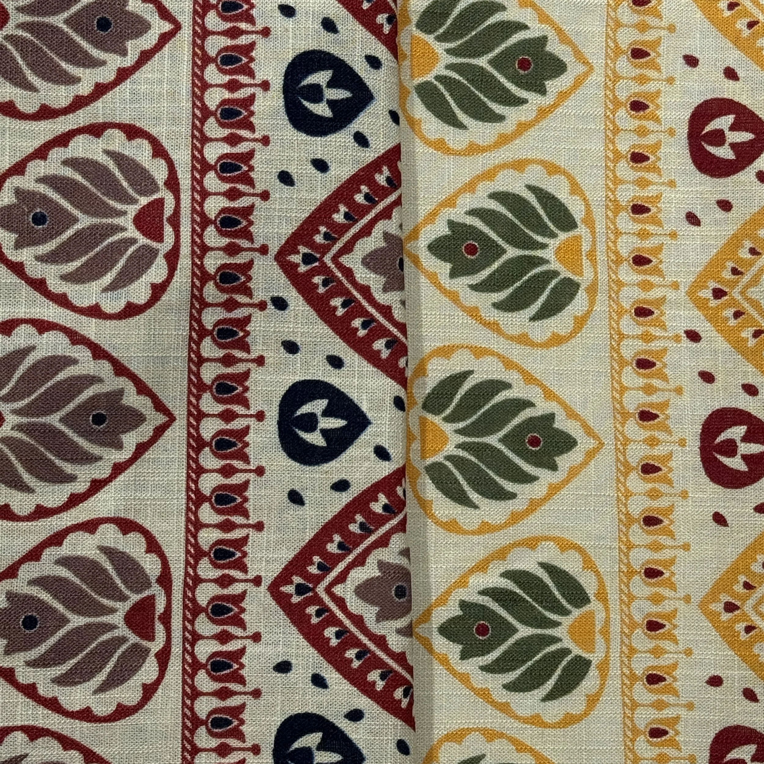 Colorful, ornate fabric with red, navy blue, yellow, and green patterns arranged in vertical stripes.