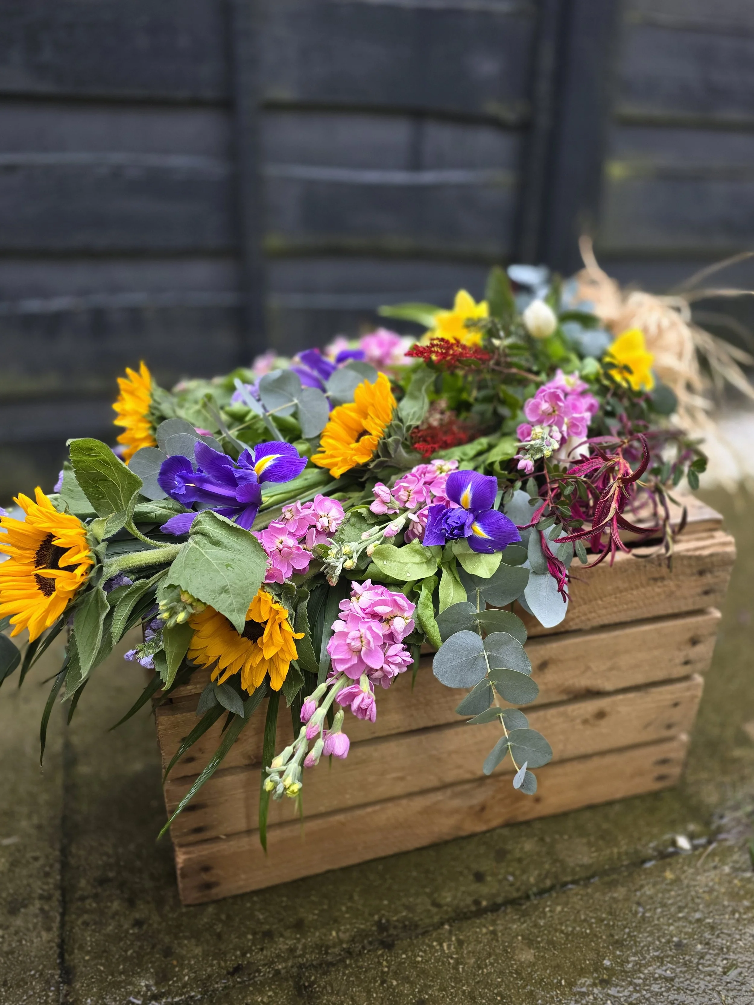 Colourful hand tied funeral flowers