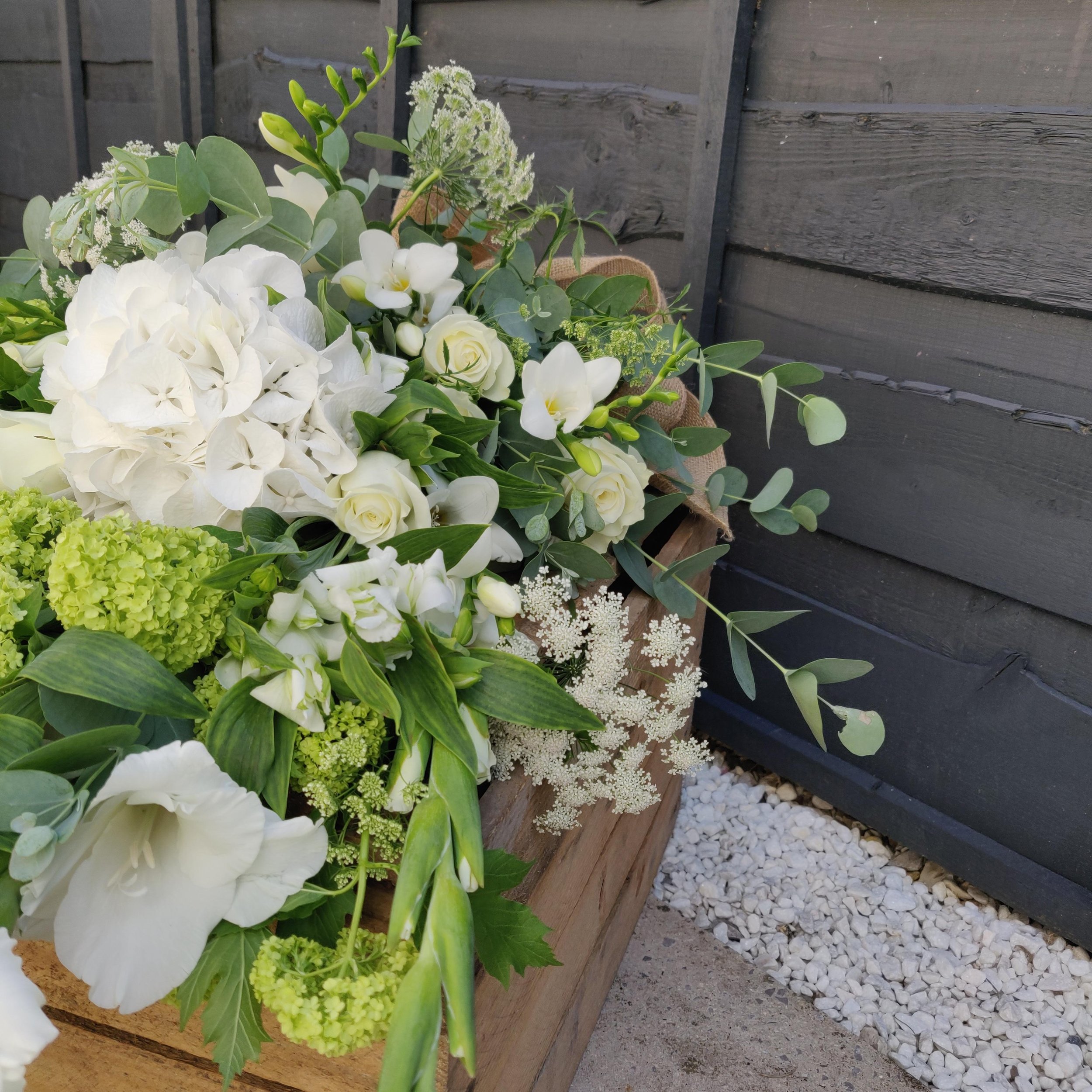 White and green hand tied funeral flowers