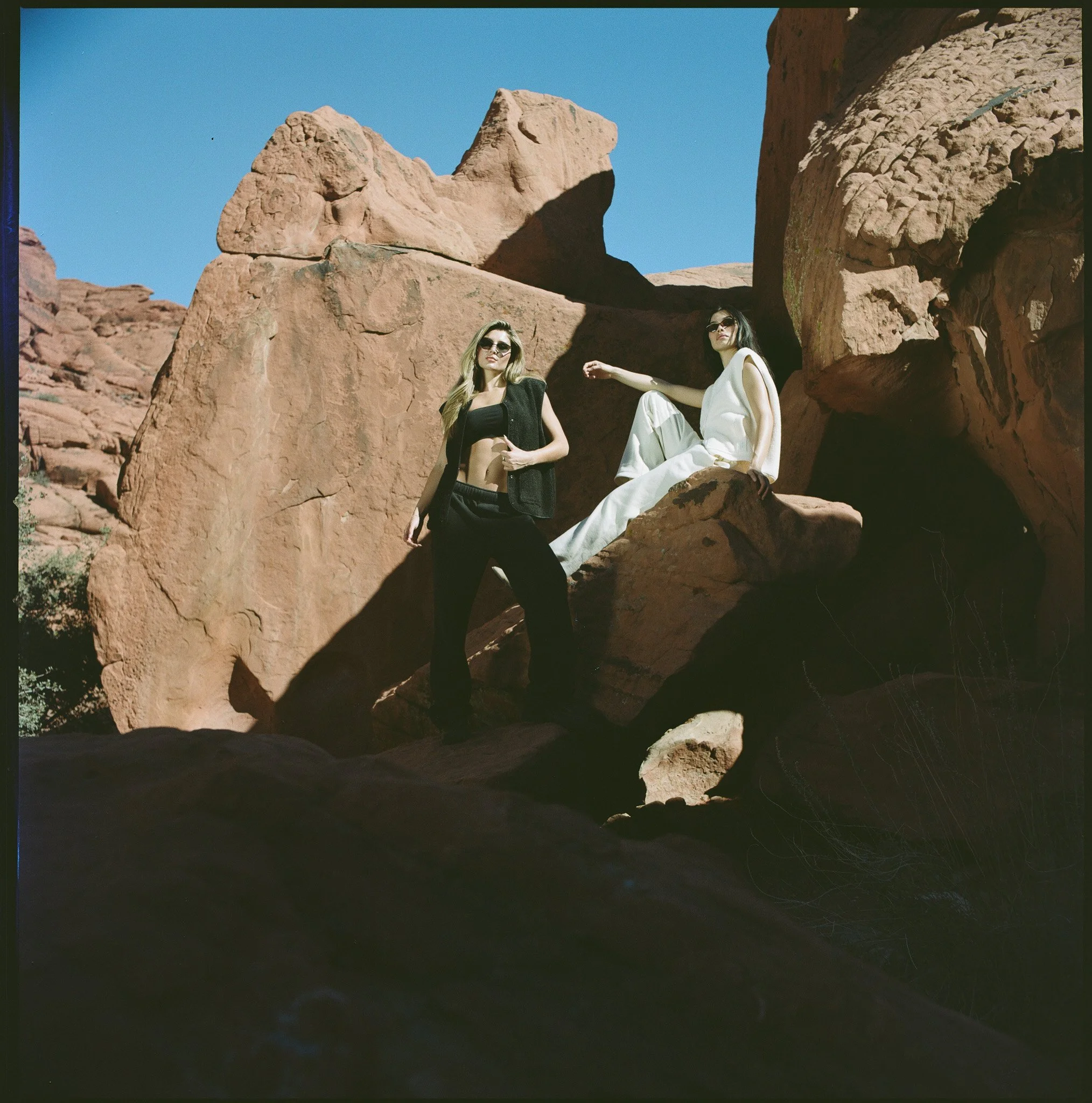 models pose on location, in the desert of Nevada outside of Las Vegas, for 4th Arq's spring summer 2026 fashion campaign, photographed on film by Andrew and Sam of Indie Studios. Lifestyle campaign shot in the graphic, timeless style of Jil Sander